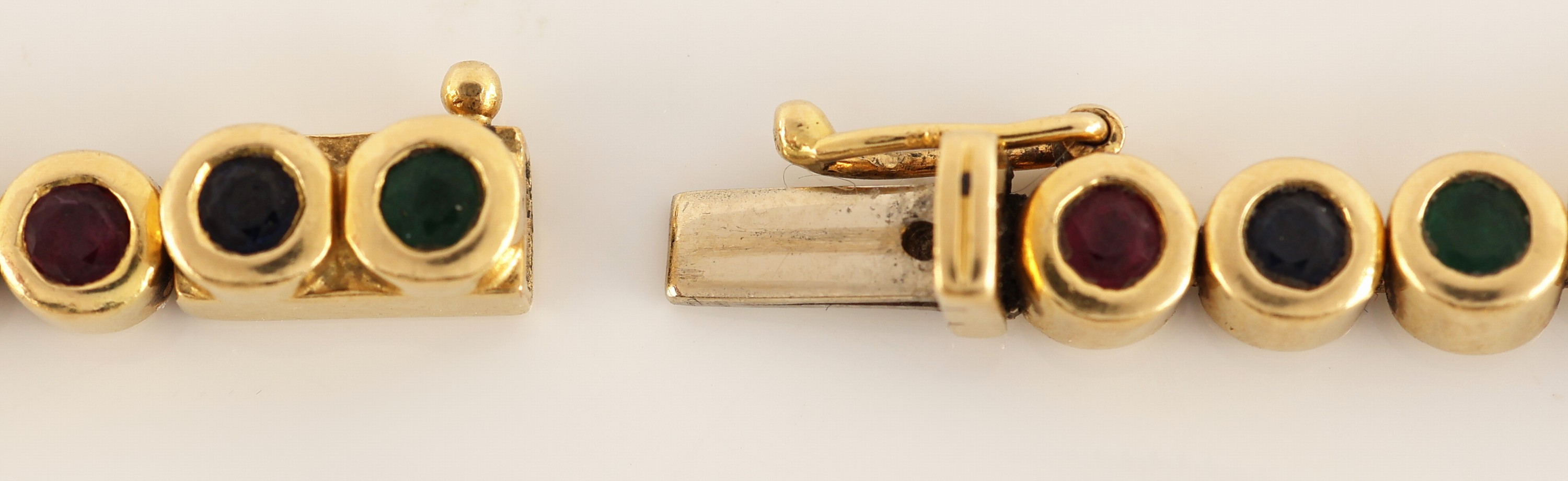 Detail c: 18 kt Gold Farbstein-Brillant-Armband, GG 750/000, 35 rundfacett. Saphire, Rubine und Smaragde zus. ca. 1.80 ct, 1 Stein fehlt, 11 Brillanten zus. ...