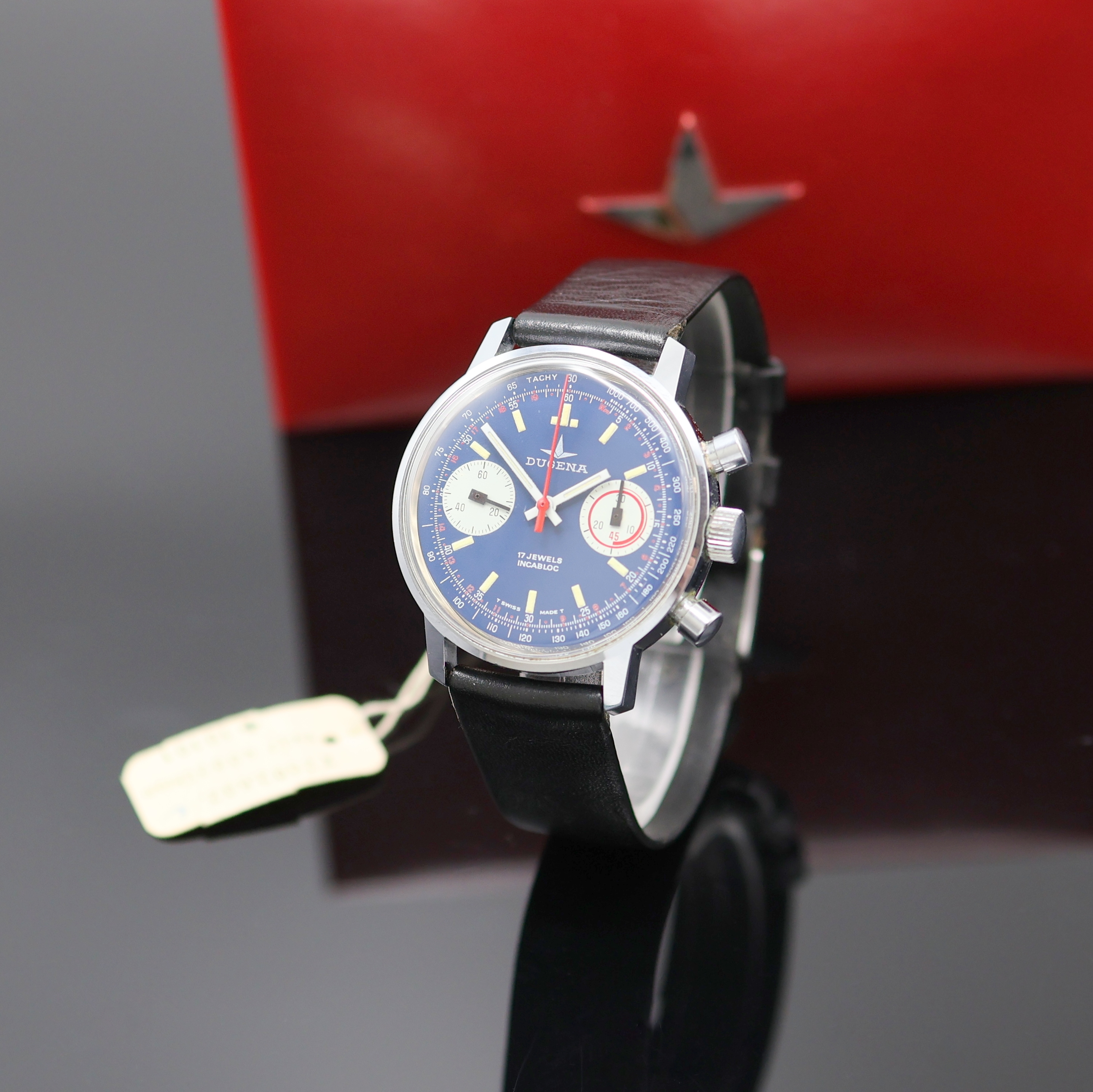 DUGENA Herrenarmbanduhr mit Chronograph, Handaufzug, Schweiz um 1970, verchr. Geh. m. verschr. Stahlboden, blaues Zifferbl. m. Tritium-Leuchtindizes, ...
