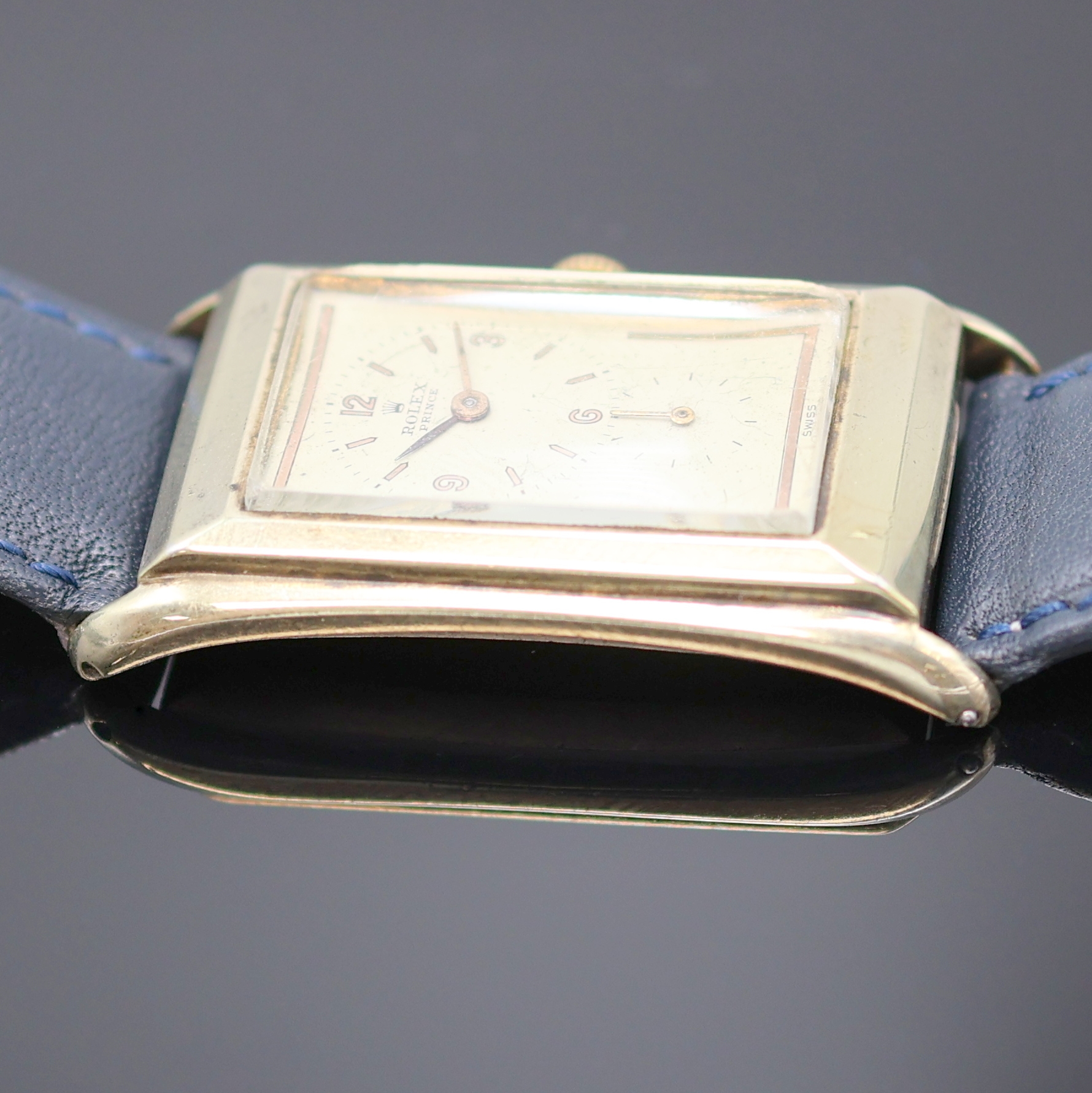 Detail e: ROLEX Prince Armbanduhr Referenz 1490, Schweiz um 1935, Handaufzug, rechteckiges, teilw. verg. Stahlgeh., Boden aufgedr., silb. Zifferbl. ...