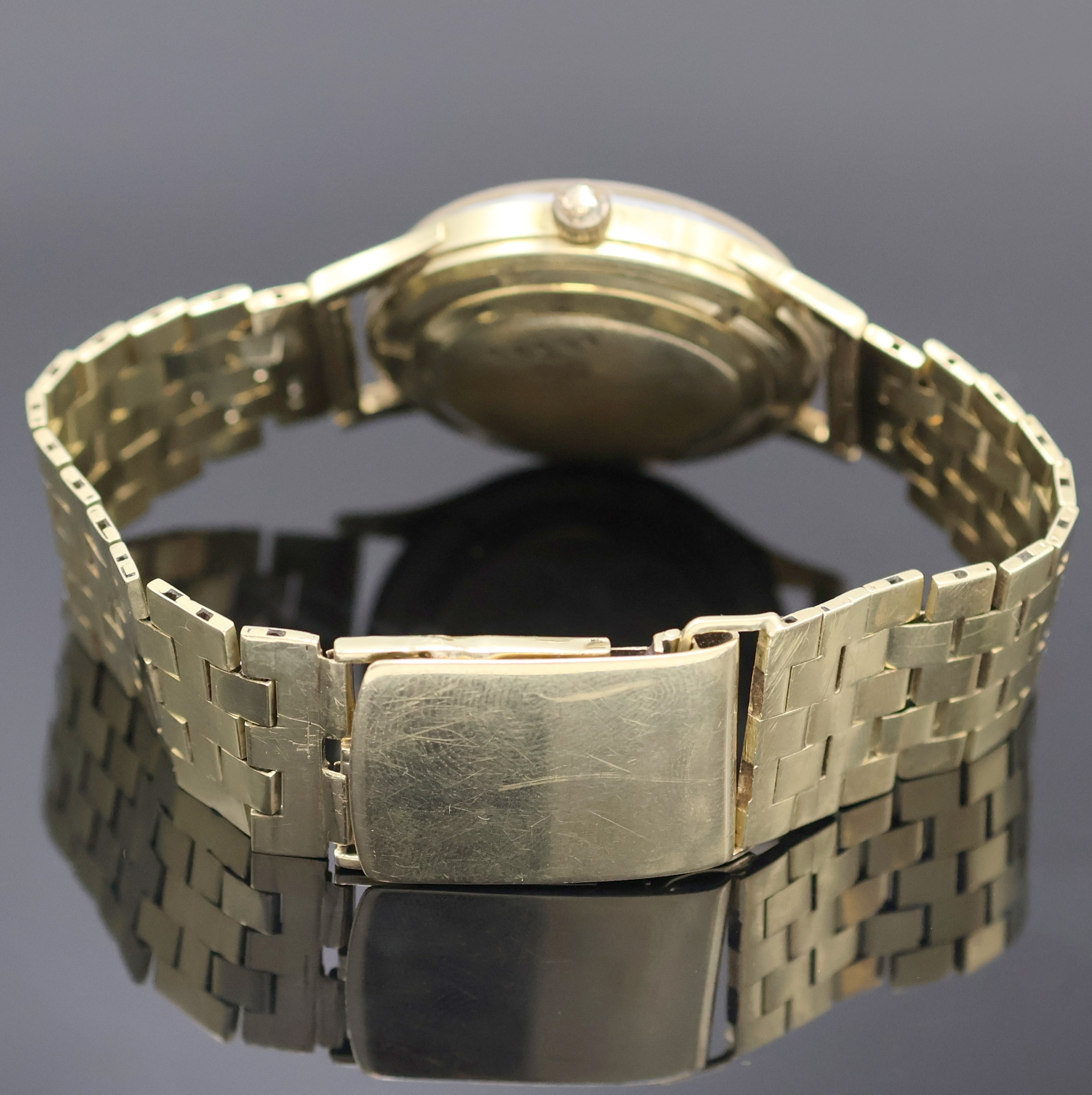 Detail b: Armbanduhr mit schweren Goldband in GG 585/000, Schweiz um 1960, Automatik, Boden verschr., abnehmbares Band m. Faltschl., silb. Zifferbl. m. gold. ...