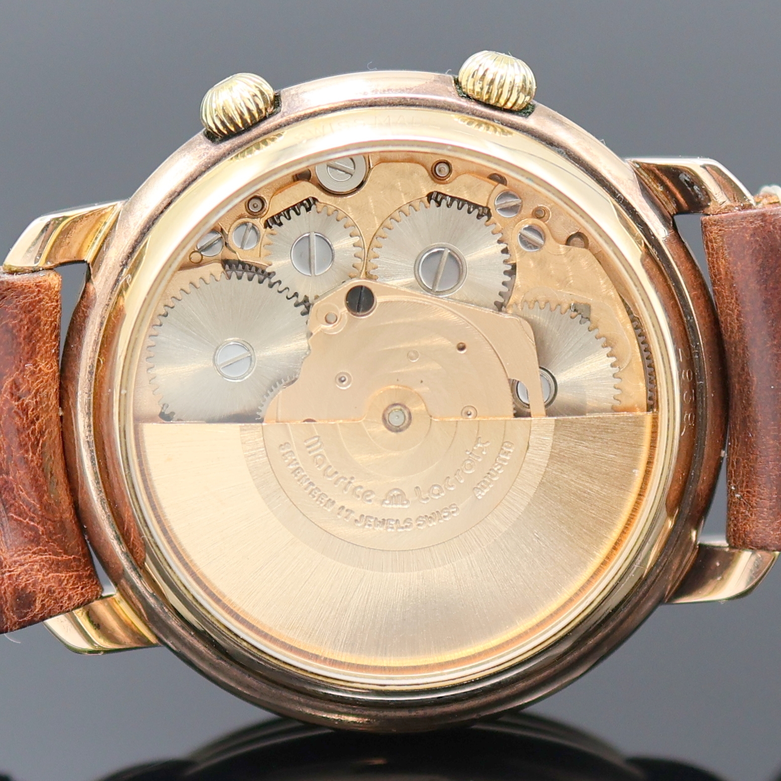 Detail e: MAURICE LACROIX Armbandwecker im vergoldeten Gehäuse, Schweiz um 1990, Automatik, beids. vergl., rotverg. Geh., Boden aufgedr., translucid lack. ...