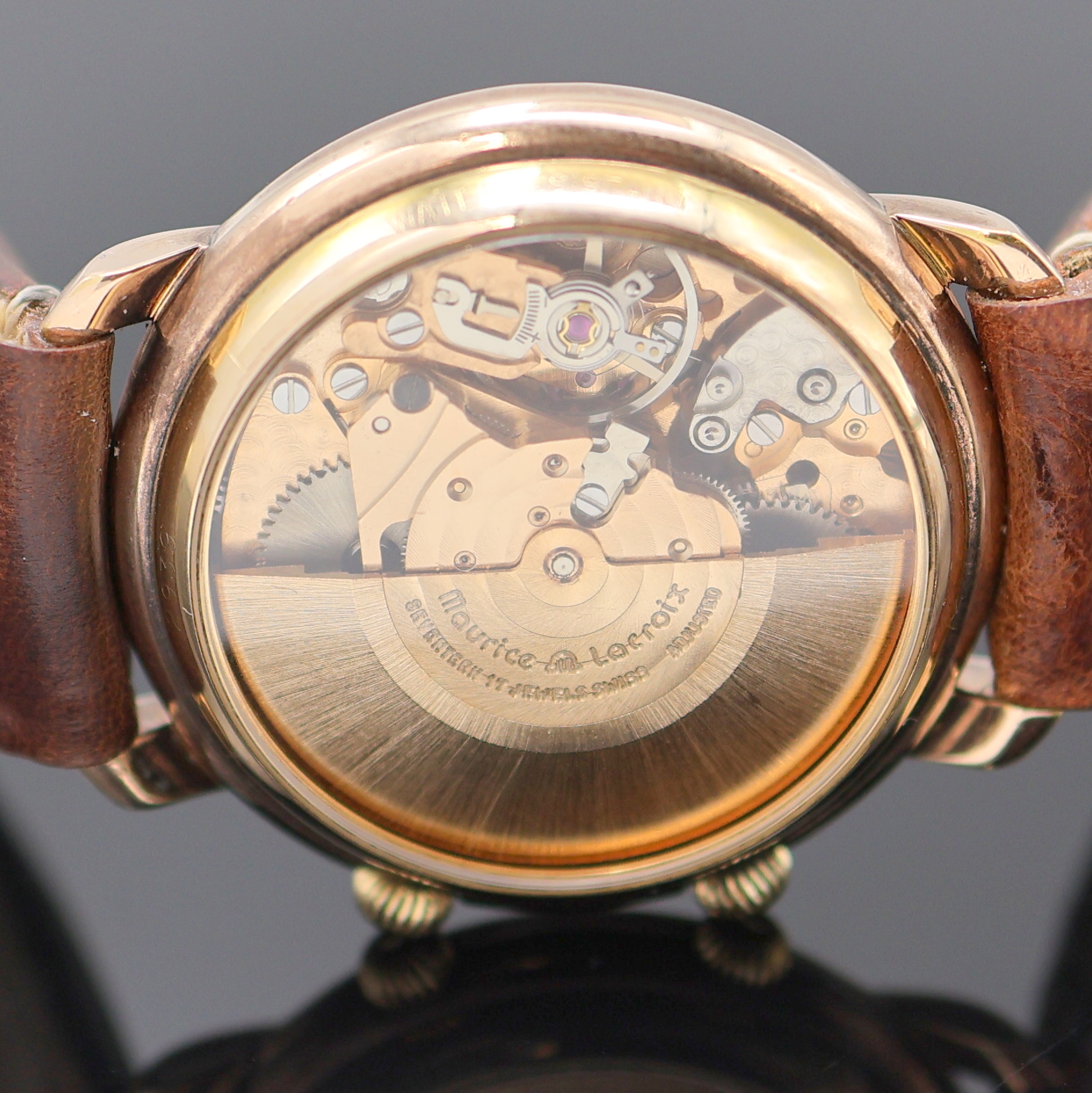 Detail f: MAURICE LACROIX Armbandwecker im vergoldeten Gehäuse, Schweiz um 1990, Automatik, beids. vergl., rotverg. Geh., Boden aufgedr., translucid lack. ...