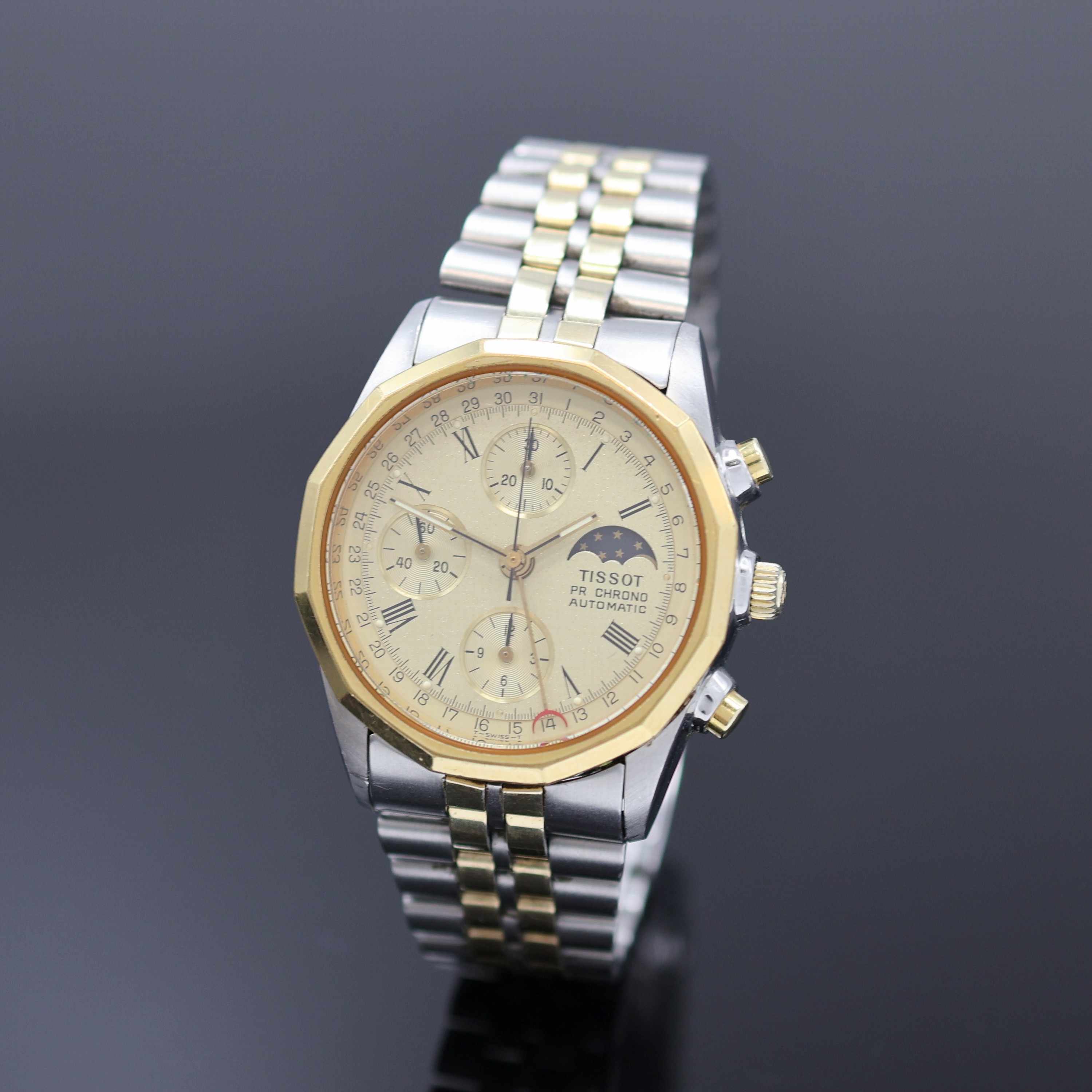 TISSOT PR 100 Herrenchronograph in Stahl/ vergoldet, Schweiz um 1980, Automatik, verschr. Geh., 12-eckig facettierte Lünette, orig. Band m. ...