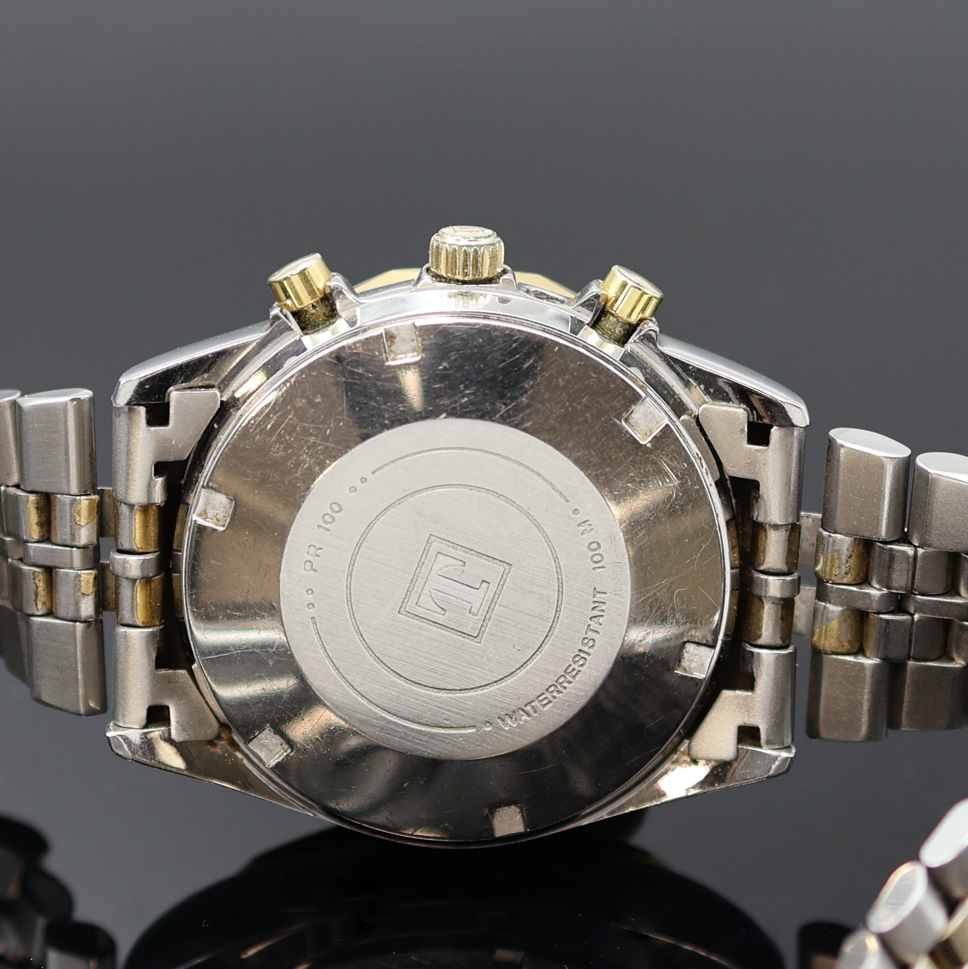 Detail d: TISSOT PR 100 Herrenchronograph in Stahl/ vergoldet, Schweiz um 1980, Automatik, verschr. Geh., 12-eckig facettierte Lünette, orig. Band m. ...