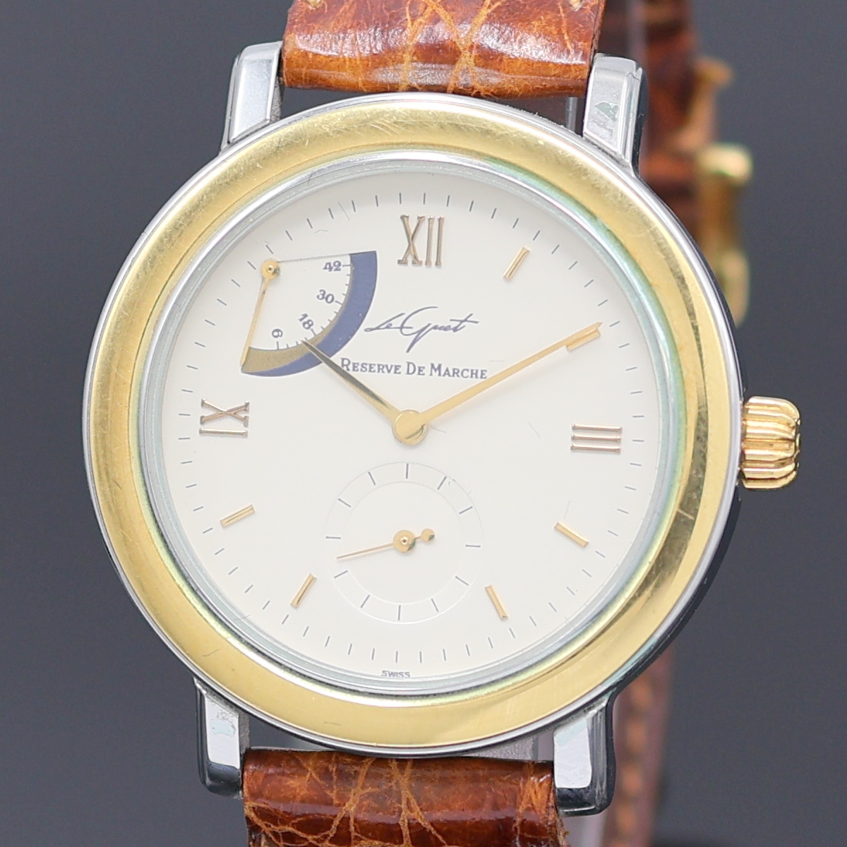 Detail a: LE GUET DU TEMPS Neuchâtel Armbanduhr Referenz 2640, Schweiz um 1990, Handaufzug, Stahlgeh. m. GG 750/000 Lünette, aufgedr. Boden m. Sicht auf ...
