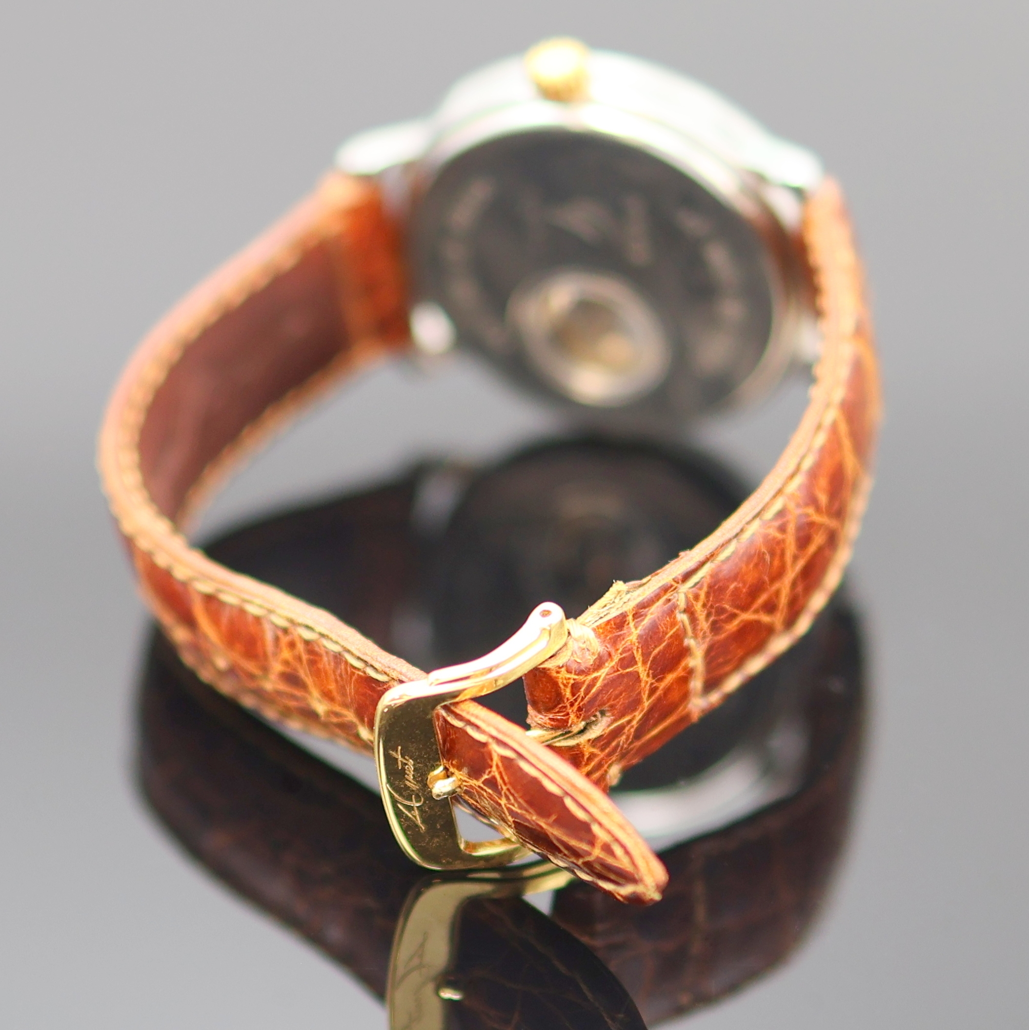 Detail c: LE GUET DU TEMPS Neuchâtel Armbanduhr Referenz 2640, Schweiz um 1990, Handaufzug, Stahlgeh. m. GG 750/000 Lünette, aufgedr. Boden m. Sicht auf ...