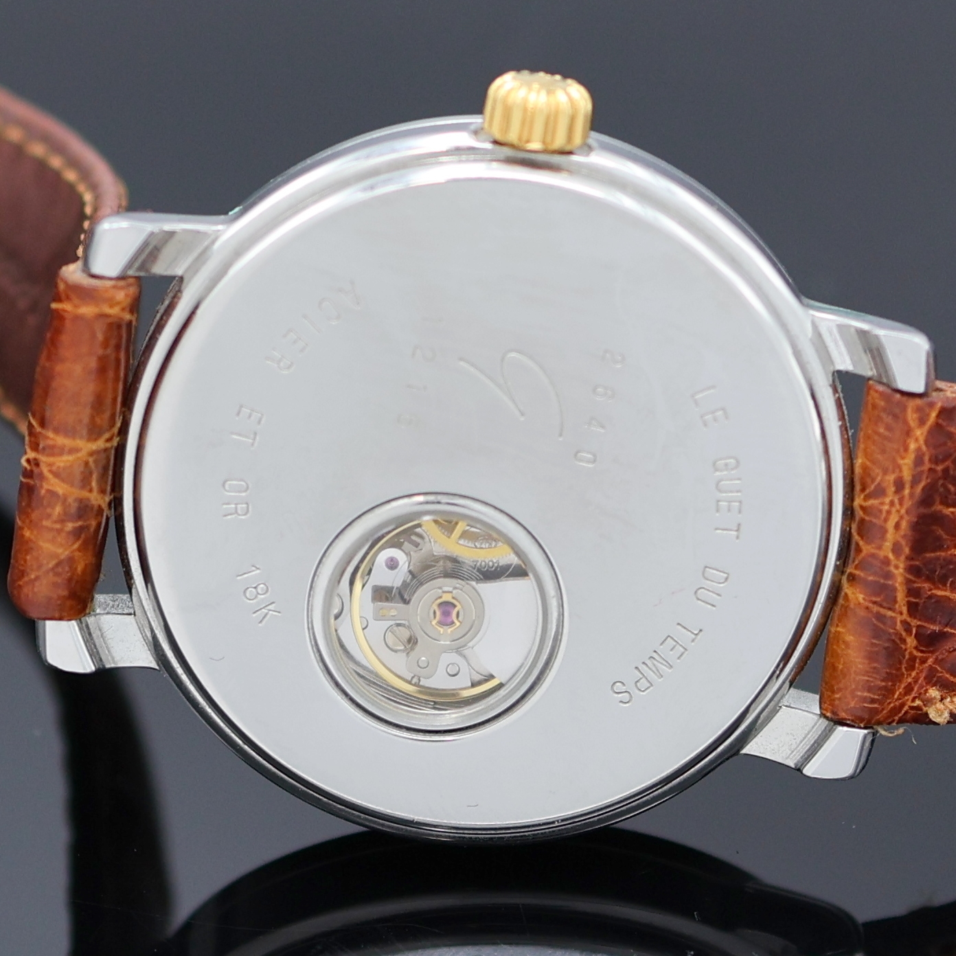 Detail e: LE GUET DU TEMPS Neuchâtel Armbanduhr Referenz 2640, Schweiz um 1990, Handaufzug, Stahlgeh. m. GG 750/000 Lünette, aufgedr. Boden m. Sicht auf ...