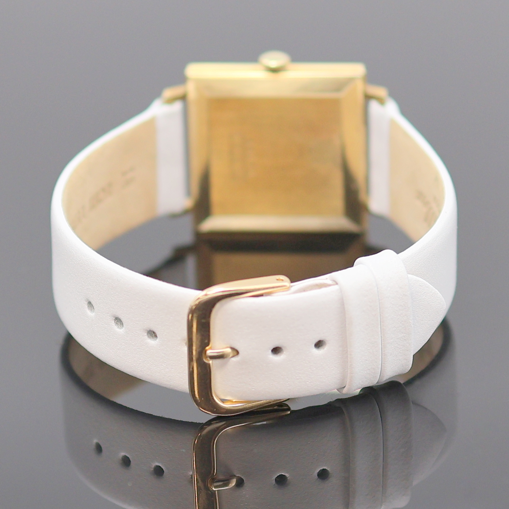 Detail b: DUGENA Precision quadratische Armbanduhr in GG 585/000, Schweiz um 1965, Handaufzug, Boden aufgedr., silb. Strukturzifferbl. m. gold. Std.-Ind., ...