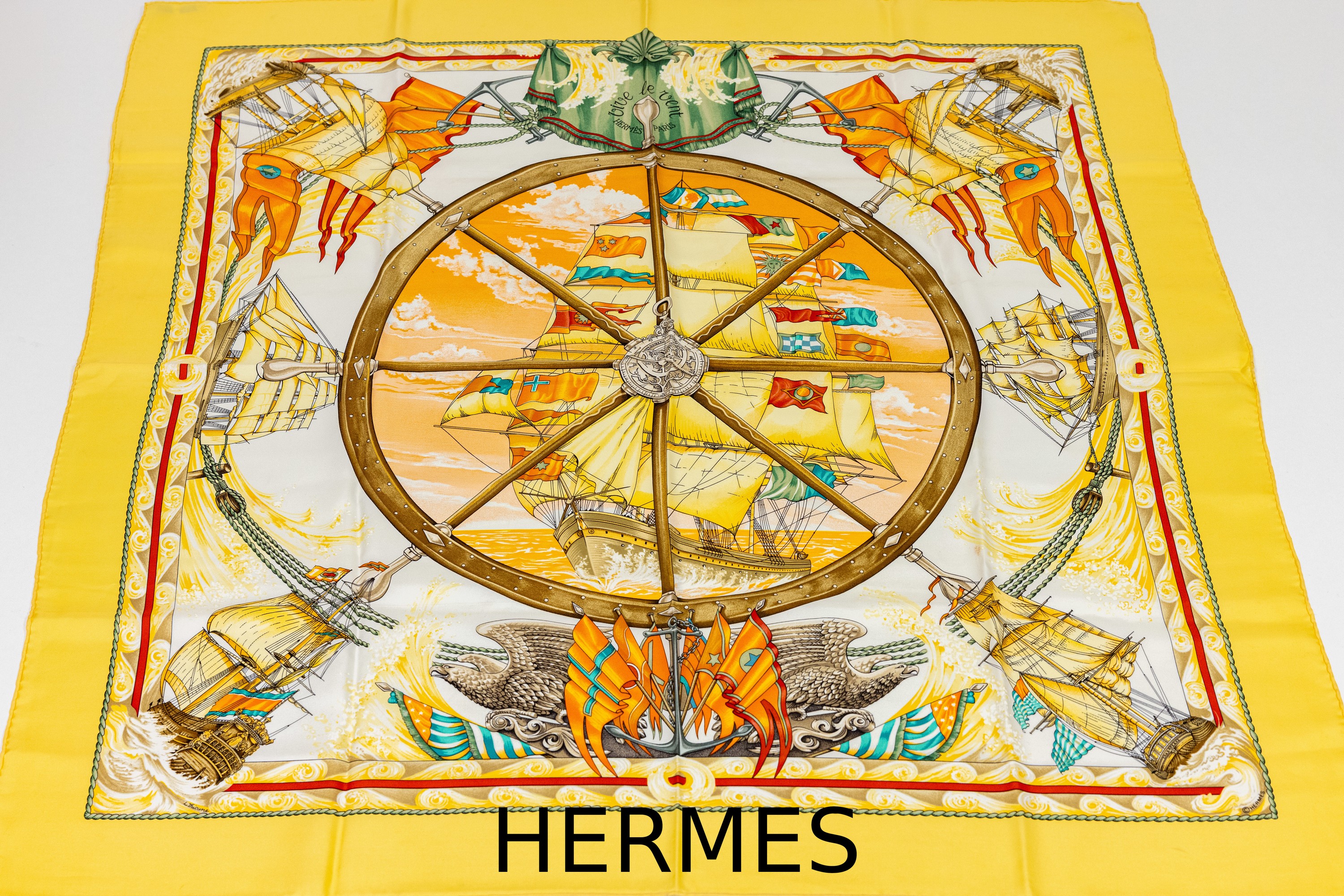 HERMES Seiden Carree "Vive Le Vent", Design Laurence Bourthoumieux, gelbgrundig, versch. Segelschiff-Motive, mittig großes Steuerrad, ca. ...
