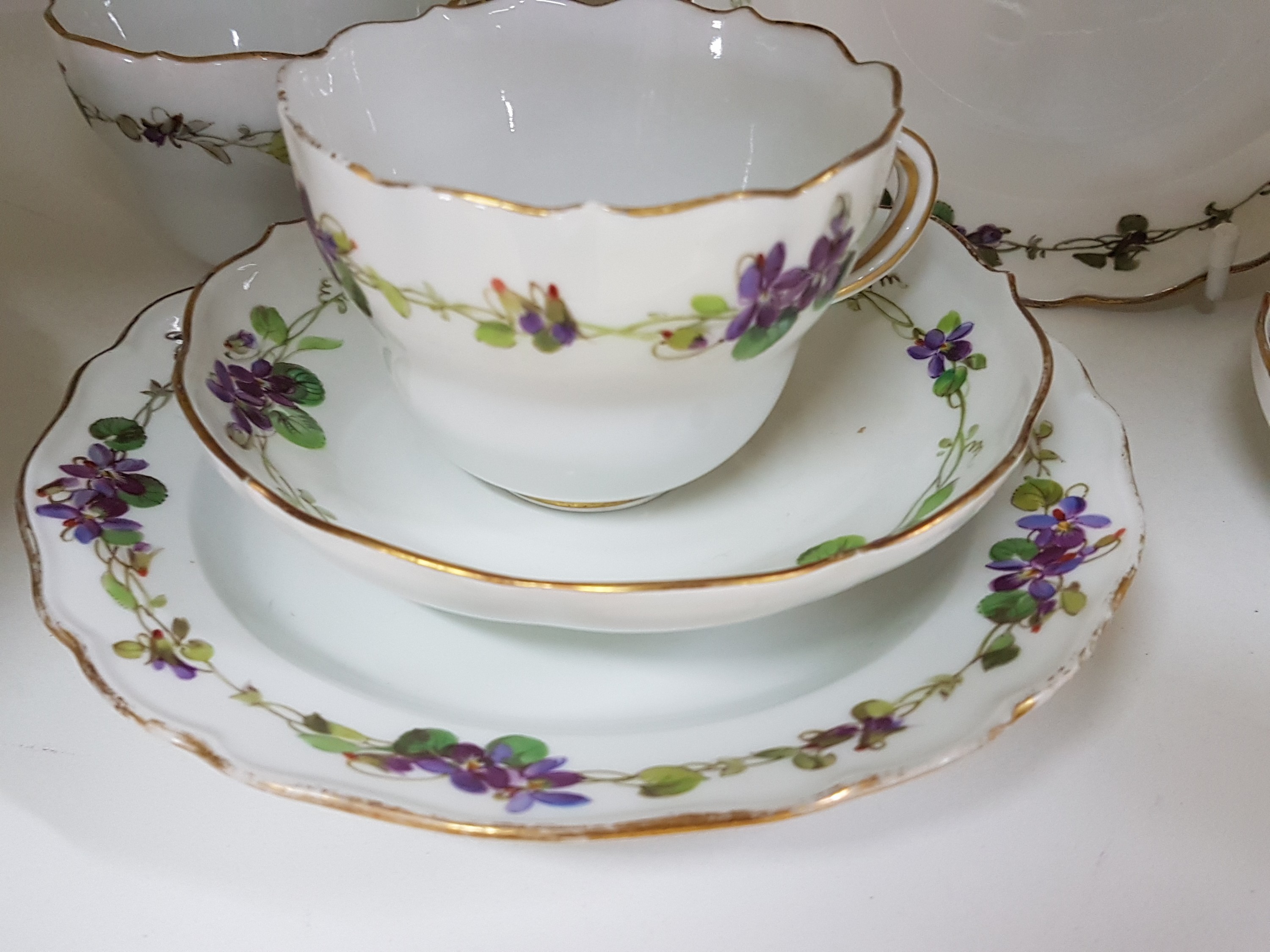 Detail b: 7 Teile Porzellan, Meissen, um 1900, 1. Wahl, mit Veilchen-Bordüren bemalt, Goldrand, 3 Tassen, 2 Untertassen, davon eine best., 2 Teller 17cm mit ...