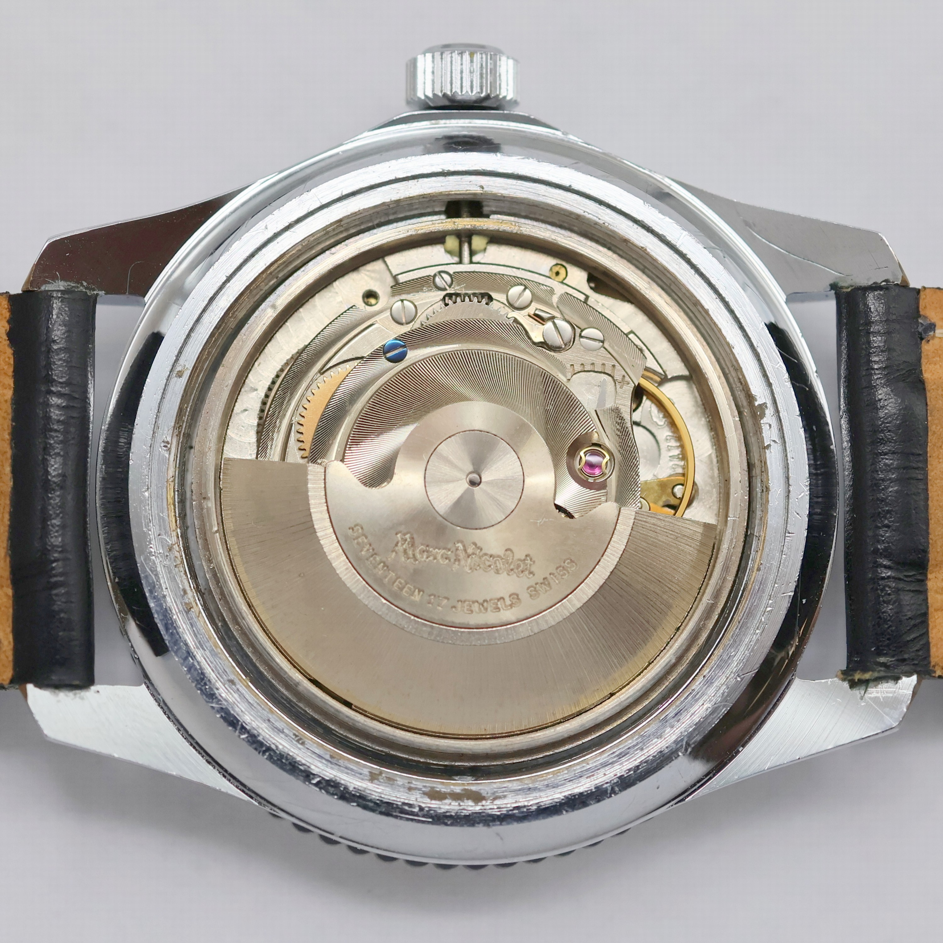 Detail e: MARC NICOLET verchromte Armbanduhr, Schweiz um 1970, Automatik, Stahlboden verschr., Lünette m. 60er teil. beids. drehb., dunkelblaues Zifferbl. m. ...
