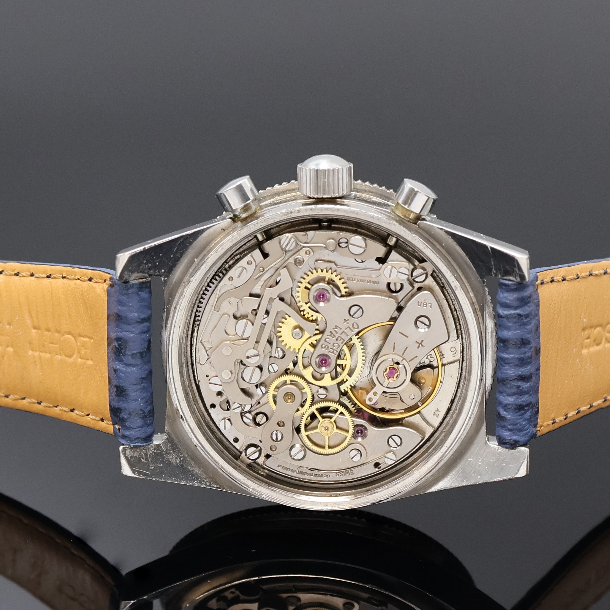 Detail d: JENNY/OLLECH & WAJS Precision Armbandchronograph, Schweiz um 1970, Handaufzug, Edelstahlgeh., Boden u. Krone verschr., Bakelitt-Lünette beids. ...