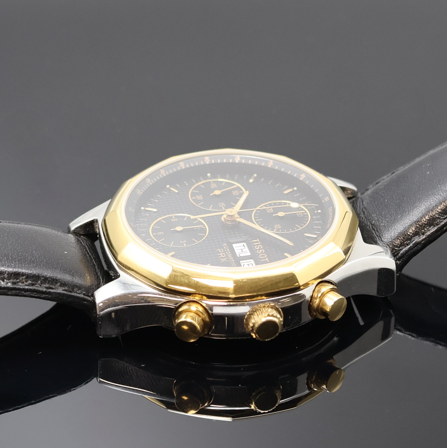 Detail c: TISSOT PRX Armbandchronograph, Schweiz um 1990, Automatik, Stahlgeh. m. verg. 12-eckiger Lünette, Boden verschr., schwarz. Waffel- Zifferbl., gold. ...