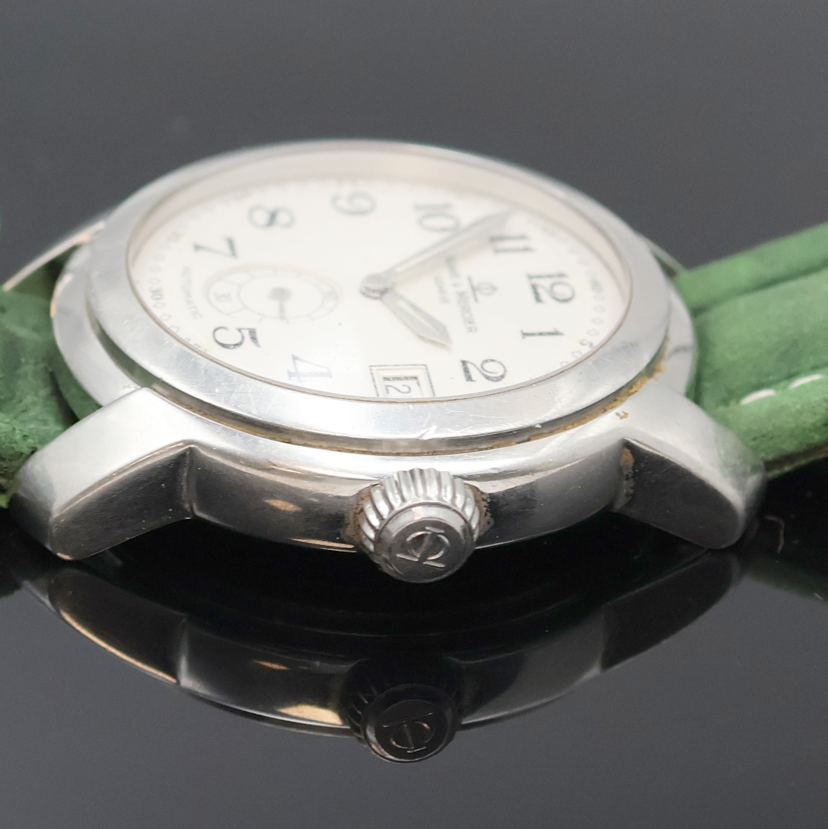 Detail d: BAUME & MERCIER Capeland Herrenarmbanduhr Referenz MV045221, Schweiz um 2005, Automatik, Edelstahlgeh., Boden u. Krone verschr., silb. Zifferbl. m. ...