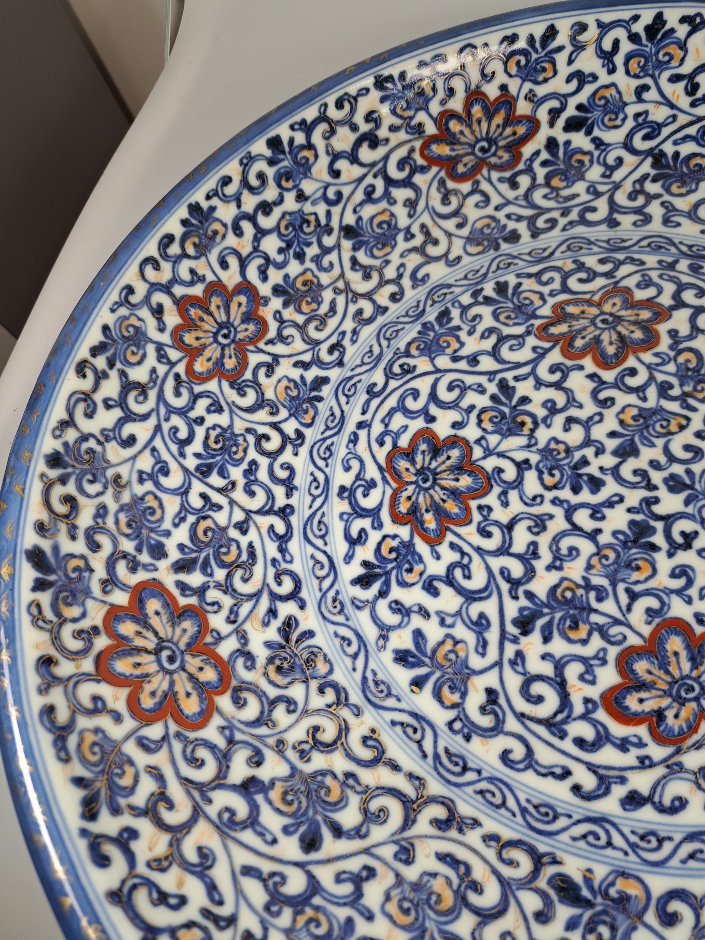 Detail b: Paar Teller, China, um 1900,, Porzellan, unterglasurblauer Dekor, Rot und Golden gehöht, Blumendekor, leicht berieben, D. 41.5 cm