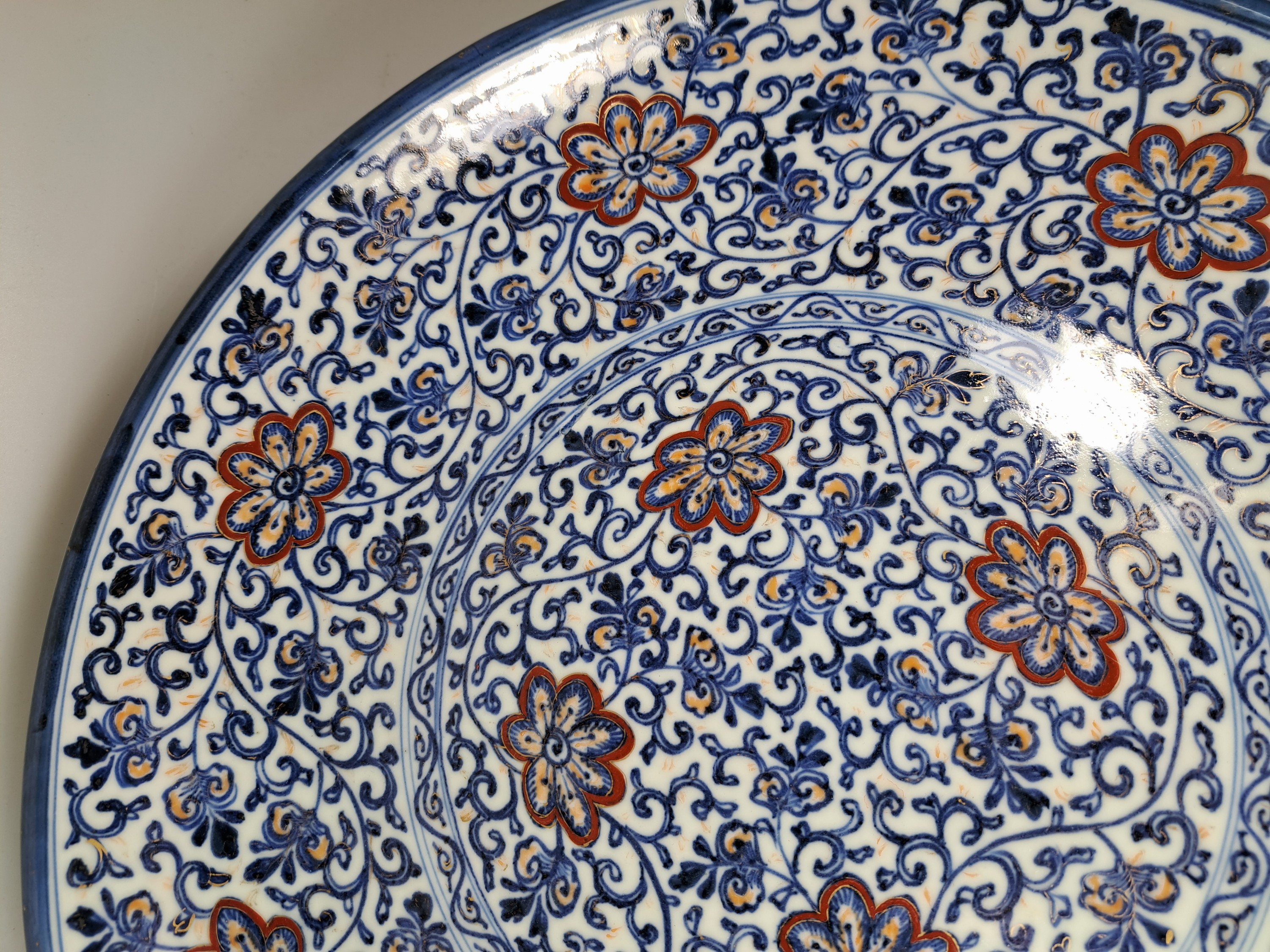 Detail c: Paar Teller, China, um 1900,, Porzellan, unterglasurblauer Dekor, Rot und Golden gehöht, Blumendekor, leicht berieben, D. 41.5 cm