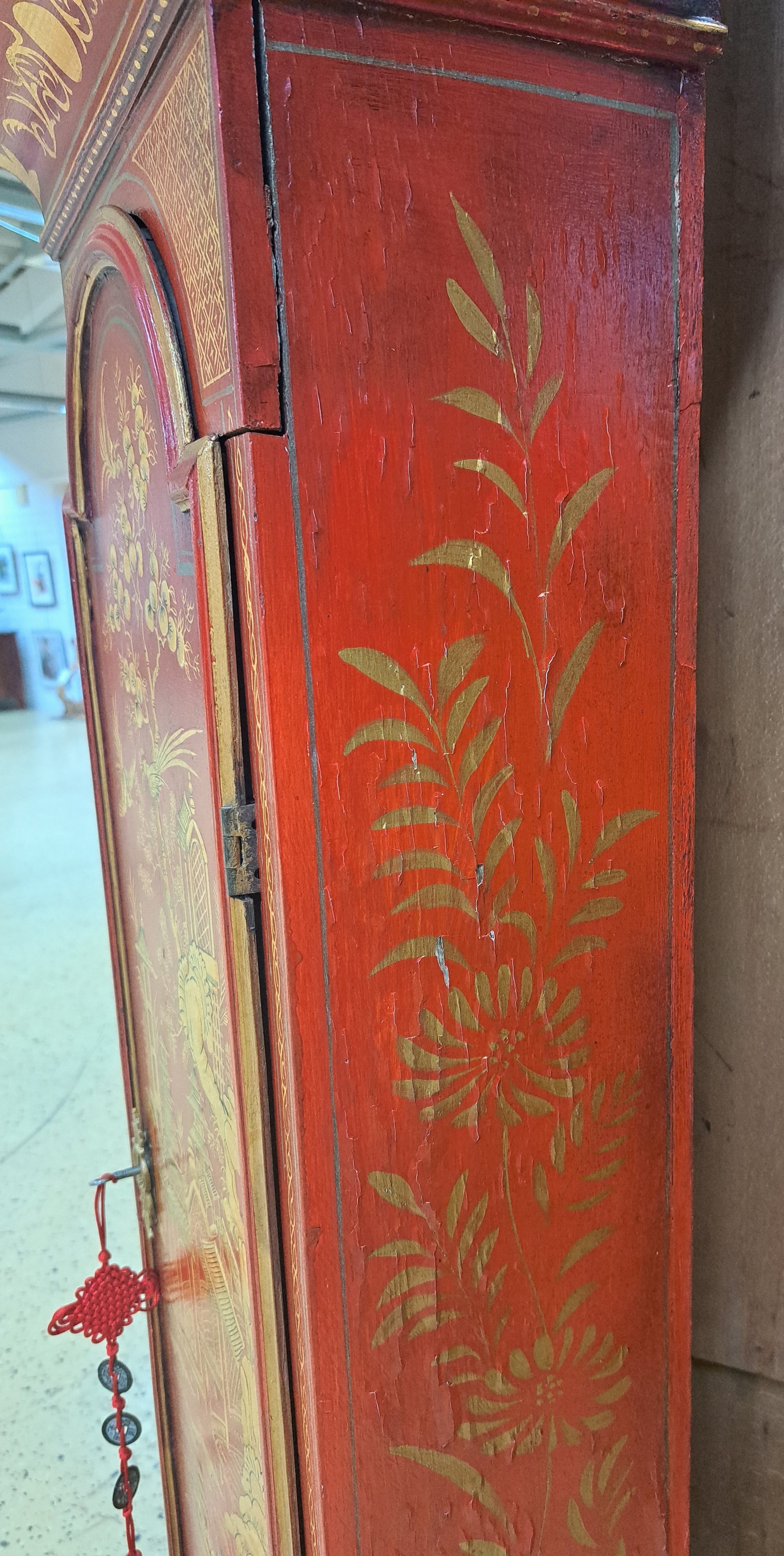 Detail e: Standuhr, England, Ende 18. Jh., einteiliges Holzgehäuse, farblich gefaßt in Chinoiserie, durchgehende Rückwand (spannungsrissig), roter Grundton ...