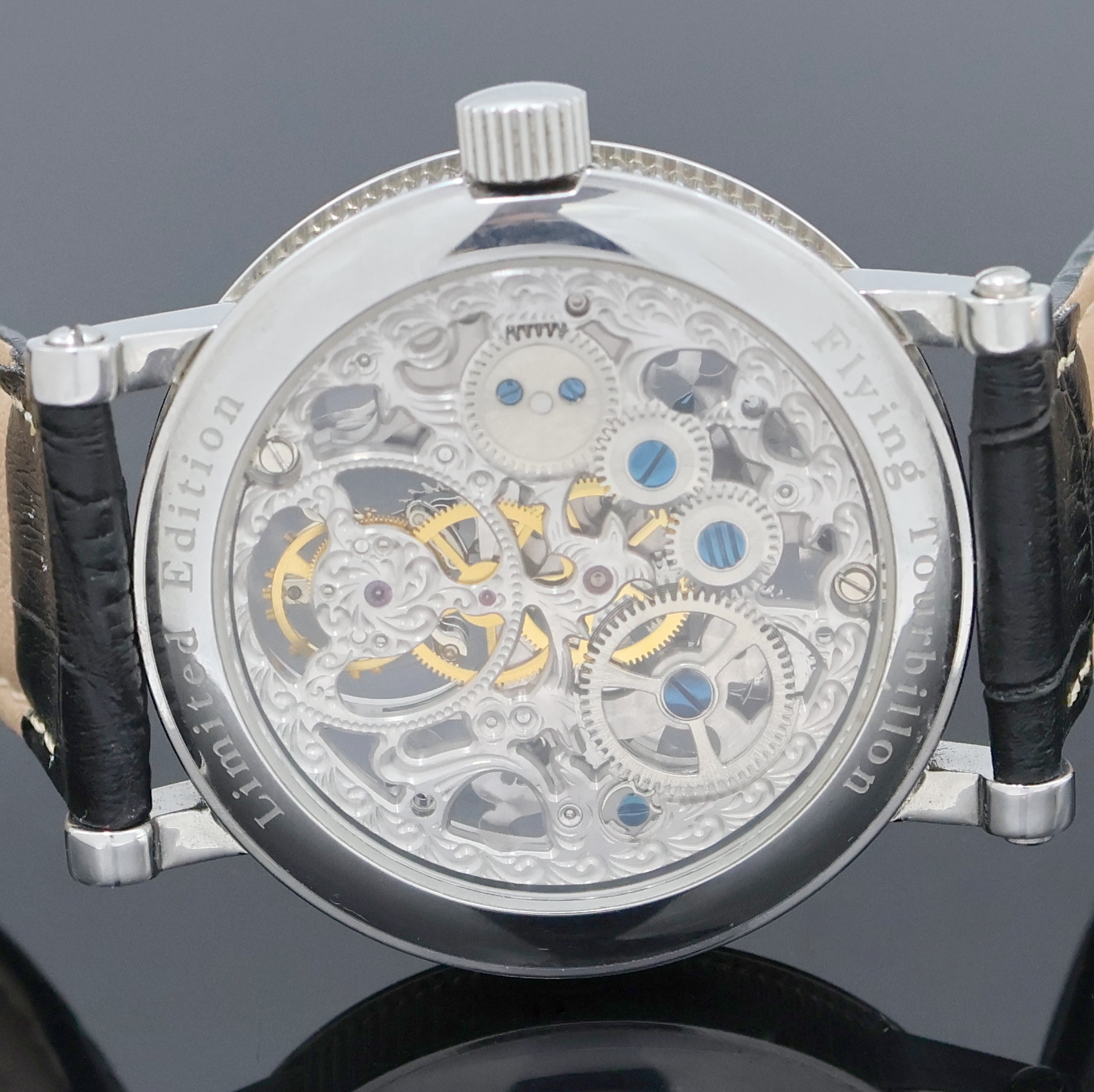 Detail e: Flying Tourbillon Herrenarmbanduhr in Stahl, China um 2000, Handaufzug, beids. vergl. Geh., aufw. floral skelett. u. grav. Werk m. gebl. Zeigern, ...