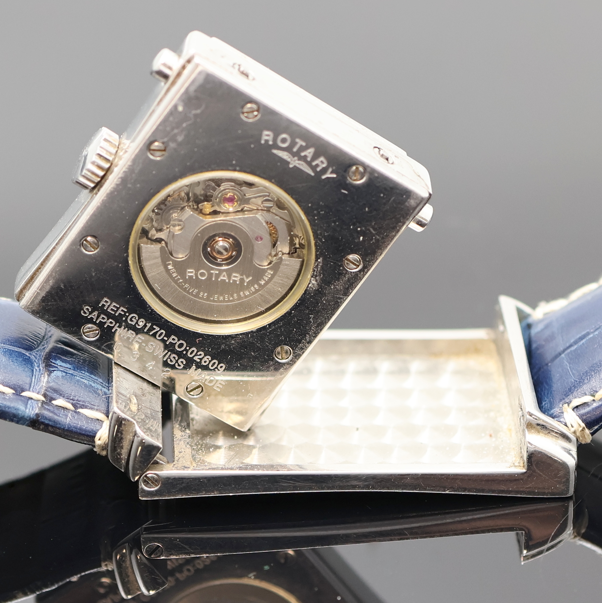 Detail d: ROTARY rechteckige drehbare Herrenarmbanduhr Referenz G9170, Schweiz um 2000, Automatik, beids. vergl. Geh., Boden 8-fach verschr., blaues ...