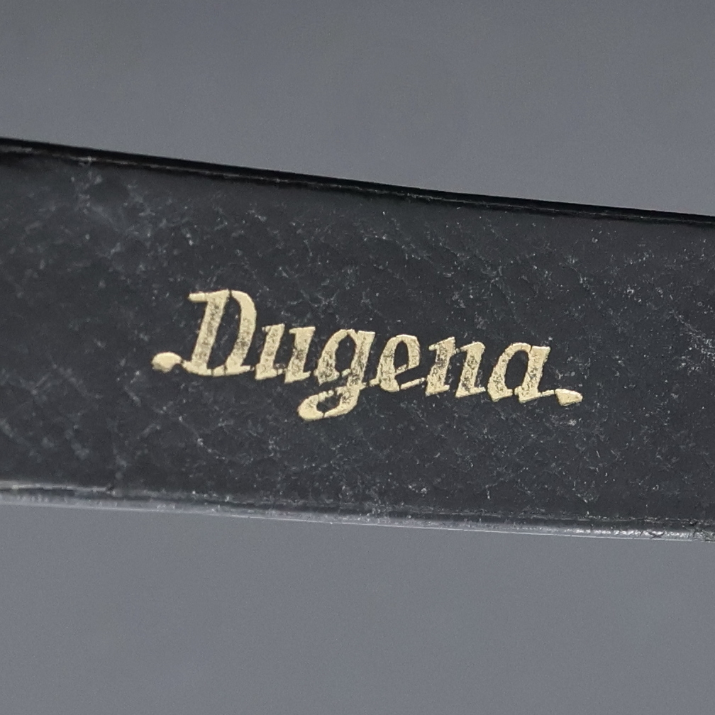 Detail e: DUGENA Festa Herrenarmbanduhr in GG 750/000, Schweiz um 1965, Handaufzug, Glasrand aufgedr., orig. Dugena Lederband m. Dornschl., silb. Zifferbl. m. ...