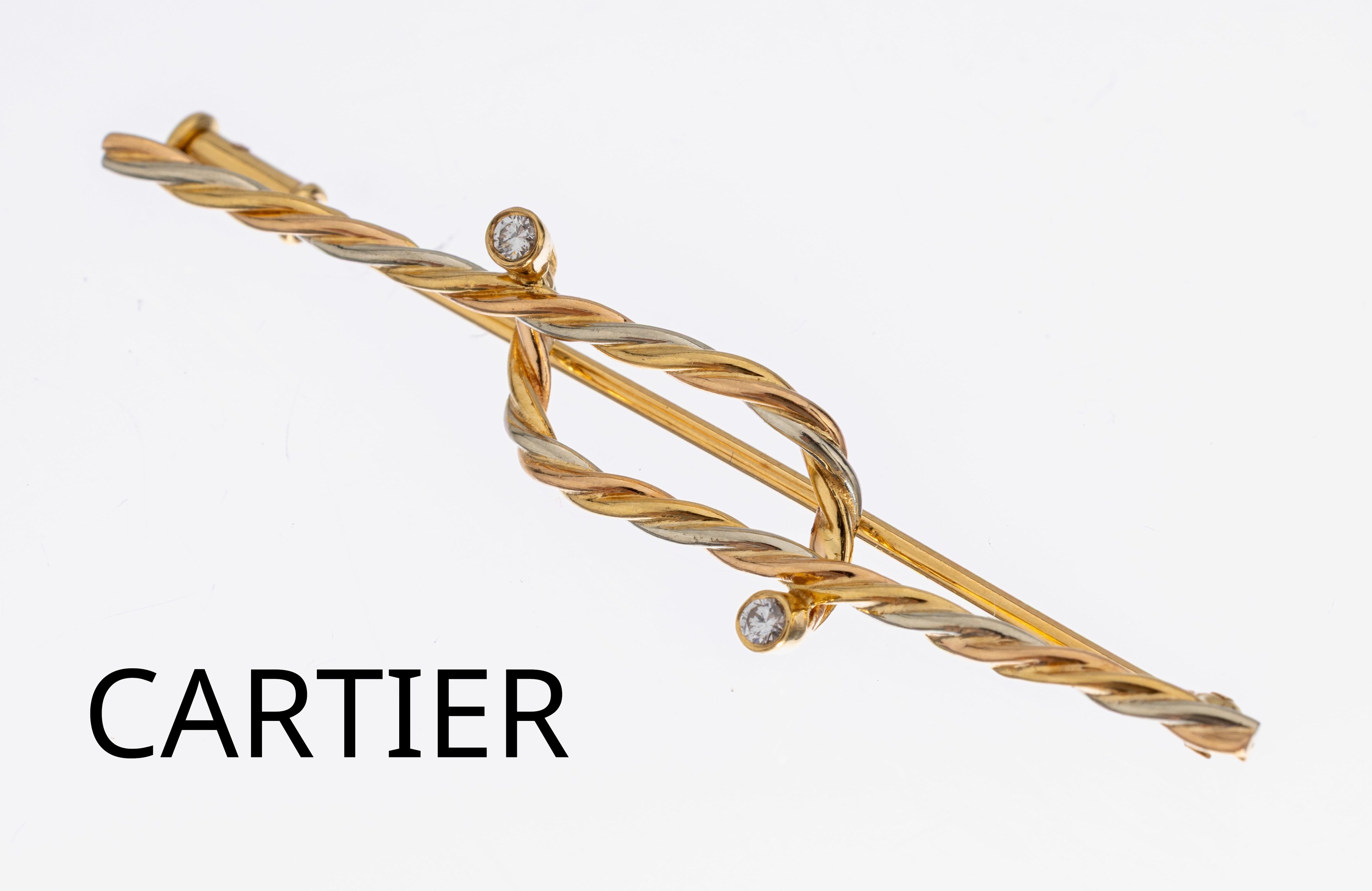 18 kt Gold CARTIER Brillant-Brosche, 1950er -60er Jahre, GG/WG 750/000, Rope Twist, gedrehte GG und WG-Drähte, 2 Brillanten zus. ca. 0.03 ct feines ...