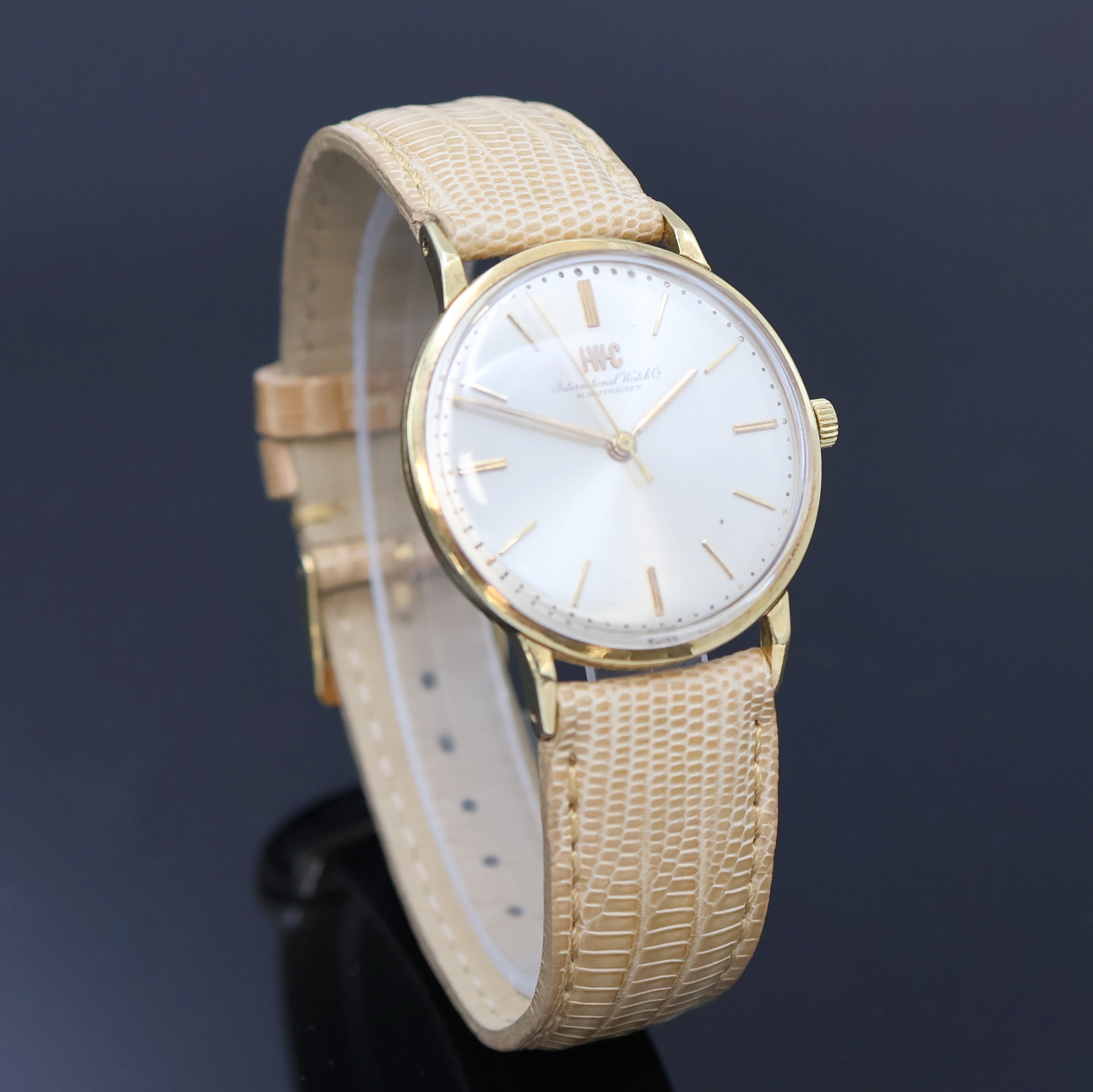 Detail b: IWC Herrenarmbanduhr in GG 750/000, Schweiz um 1962, Handaufzug, 3-tlg. Geh., Boden (dell.) u. Glasrand aufgedr., silb. Zifferbl. m. aufges. gold. ...
