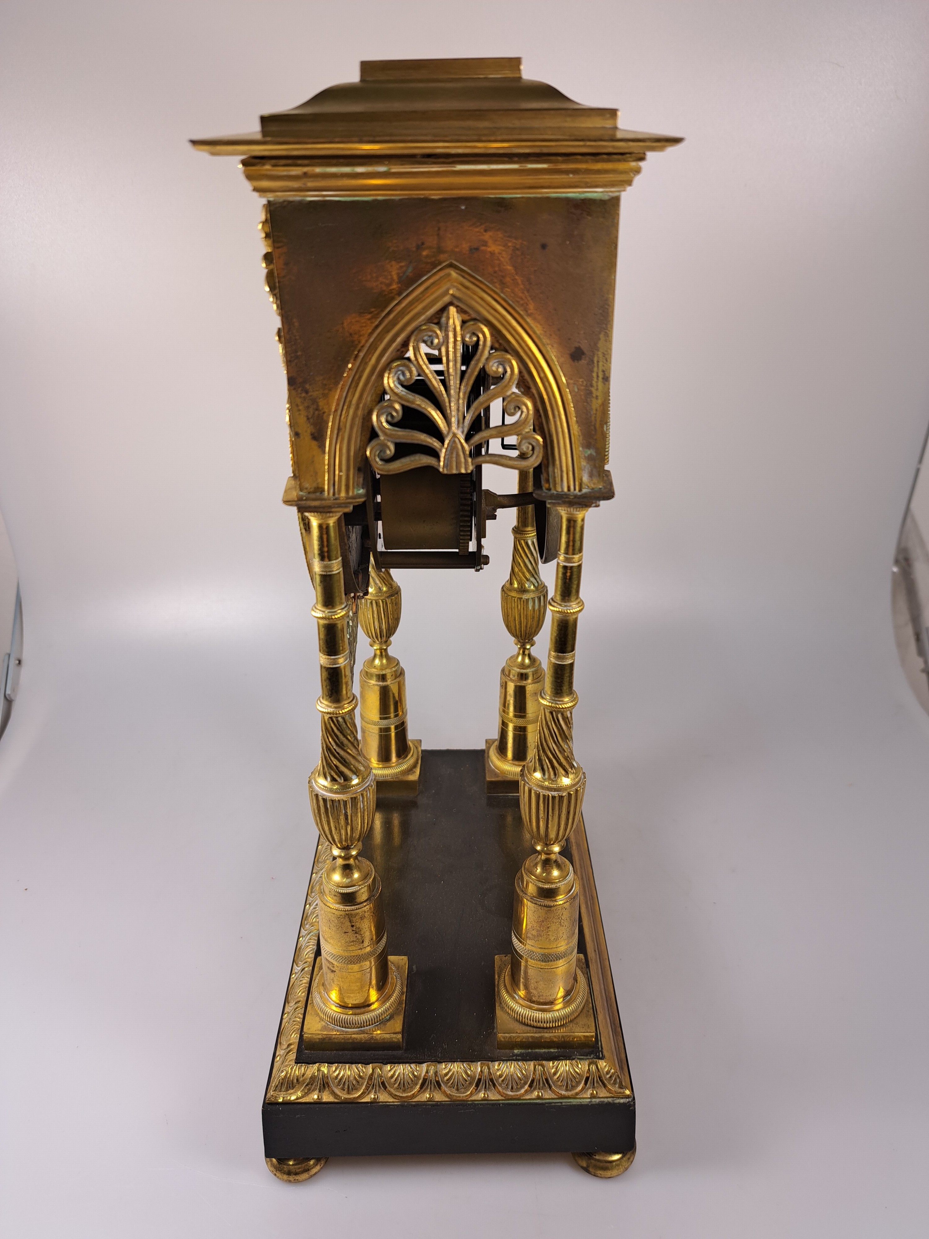 Detail d: Portaluhr, Frankreich, Mitte 19. Jh., Messinggehäuse verziert, Sockel brüniert, Uhr getragen von 4 filigranen Säulen, in den Ecken Palmetten, mit ...
