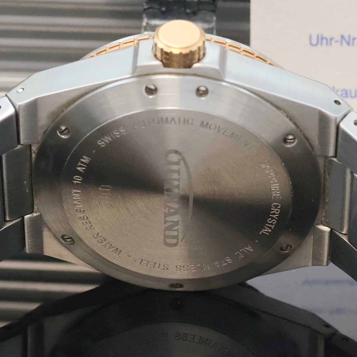 Detail d: GUINAND Herrenarmbanduhr in Stahl Referenz G2401, Schweiz verk. lt. Garantie 09/2011, Automatik, Boden u. Krone verschr., integr. Stahlband m. dopp. ...