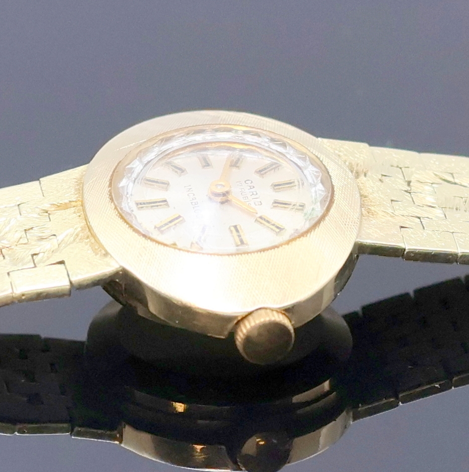 Detail c: CARIB Damenarmbanduhr in GG 585/000, Schweiz um 1965, Handaufzug, Goldband, Boden aufgedr., silb. Zifferbl. m. aufges. Std.- Ind., gold. Zeiger, Kal. ...