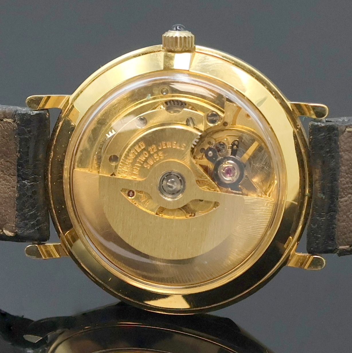 Detail d: REVUE vergoldete Armbanduhr, Schweiz um 1990, Automatik, beids. vergl. Geh., neutr. Lederband m. orig. verg. Dornschl., Schmuckkrone, champagnerfarb. ...