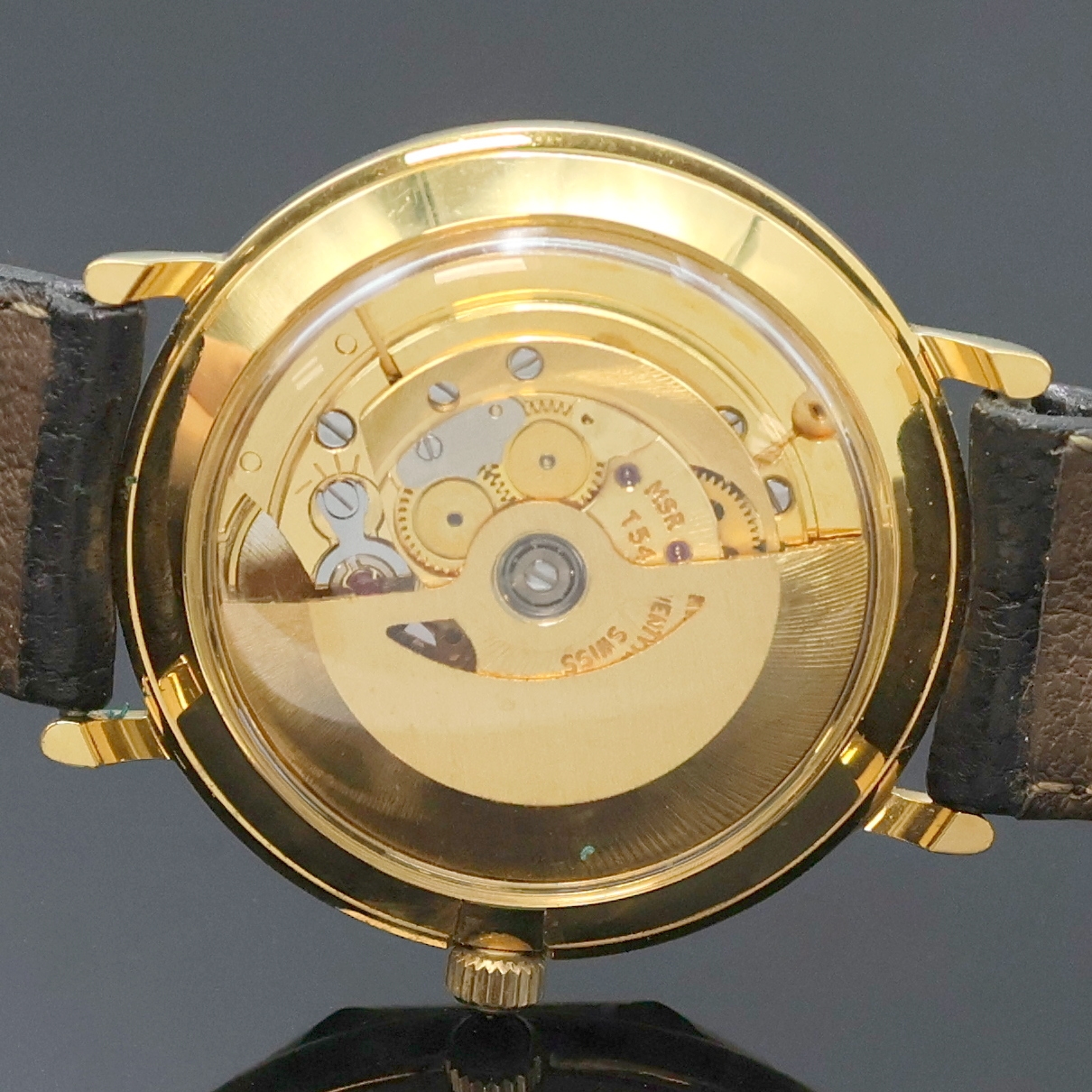 Detail e: REVUE vergoldete Armbanduhr, Schweiz um 1990, Automatik, beids. vergl. Geh., neutr. Lederband m. orig. verg. Dornschl., Schmuckkrone, champagnerfarb. ...