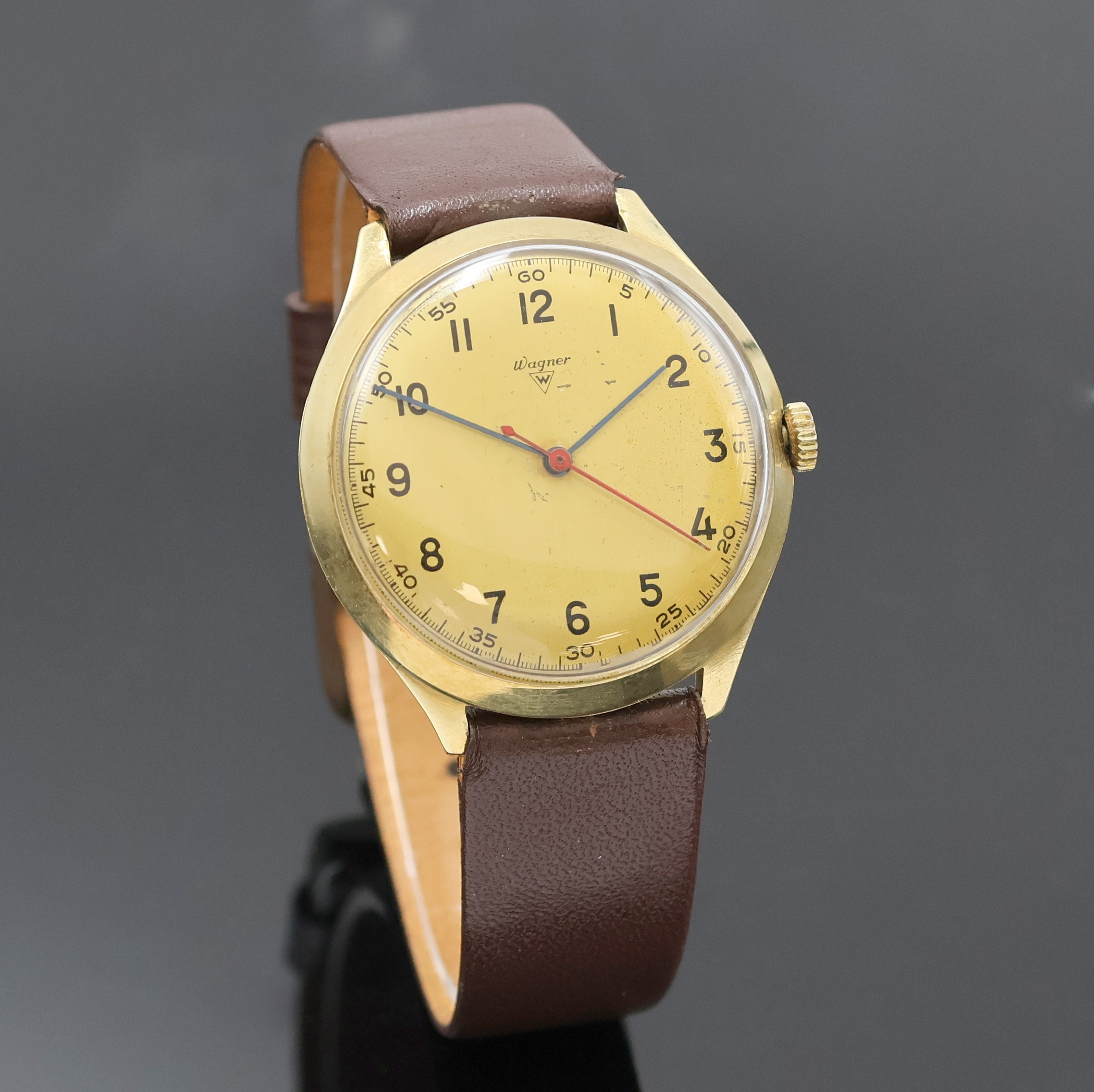 Detail b: WAGNER Armbanduhr in GG 585/000, Schweiz um 1970, Handaufzug, Boden u. Glasrand aufgedr., gold. Zifferbl. m. arab. Zahlen, gebl. Zeiger, roter ...