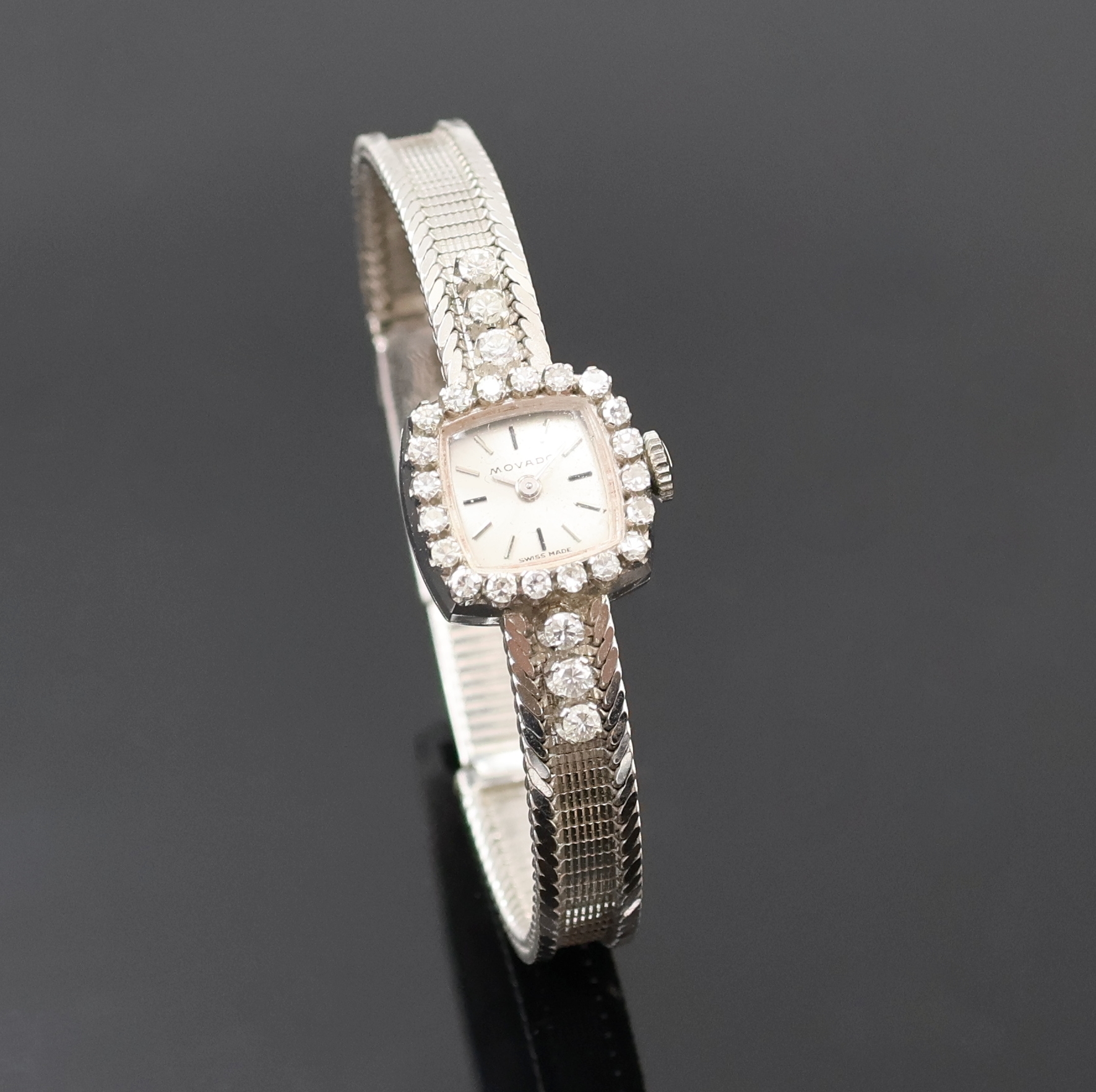 Detail b: Damenarmbanduhr bezeichnet Movado in WG 750/000 mit Diamanten, Handaufzug, Schweiz um 1970, silb. Zifferbl. m. aufgel. Indizes, Formankerw., 17 St., ...