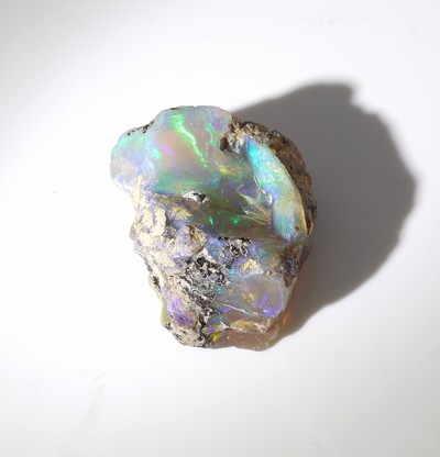 27042086b - Loose rough opal , approx. 19.20 ct, nice play of colours with bedrock Valuation Price: ...