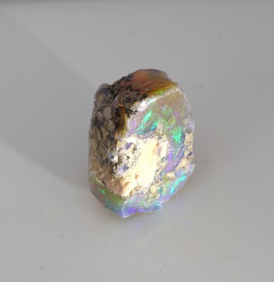 27042086d - Loose rough opal , approx. 19.20 ct, nice play of colours with bedrock Valuation Price: ...