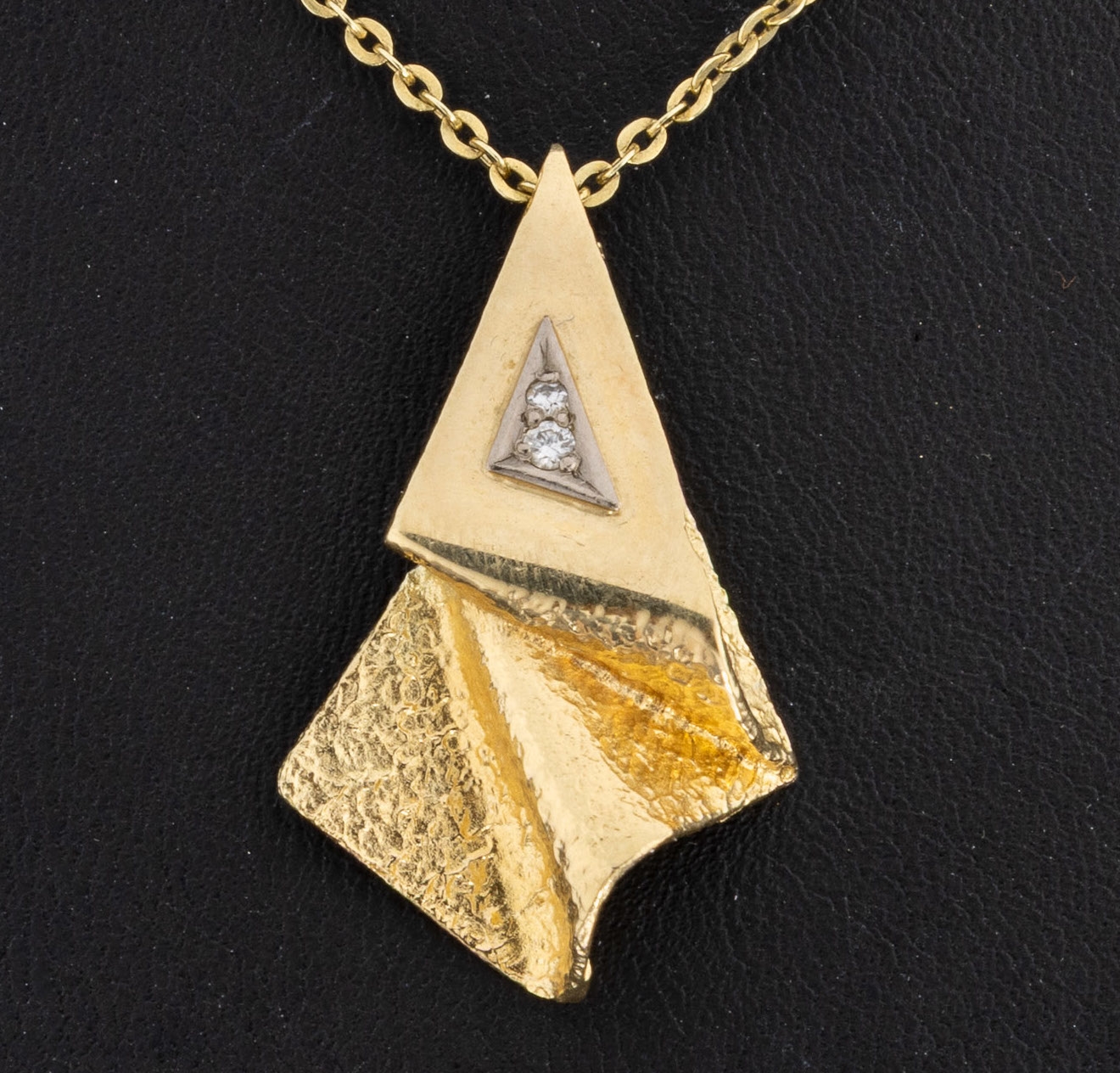 Detail a: 14 kt Gold Diamant-Anhänger, GG 585/000, abstrakte Gestaltung, Oberfläche part. strukt., 1 Brillant und 1 8/8-Diamant zus. ca.0.03 ct, an Kette, ...