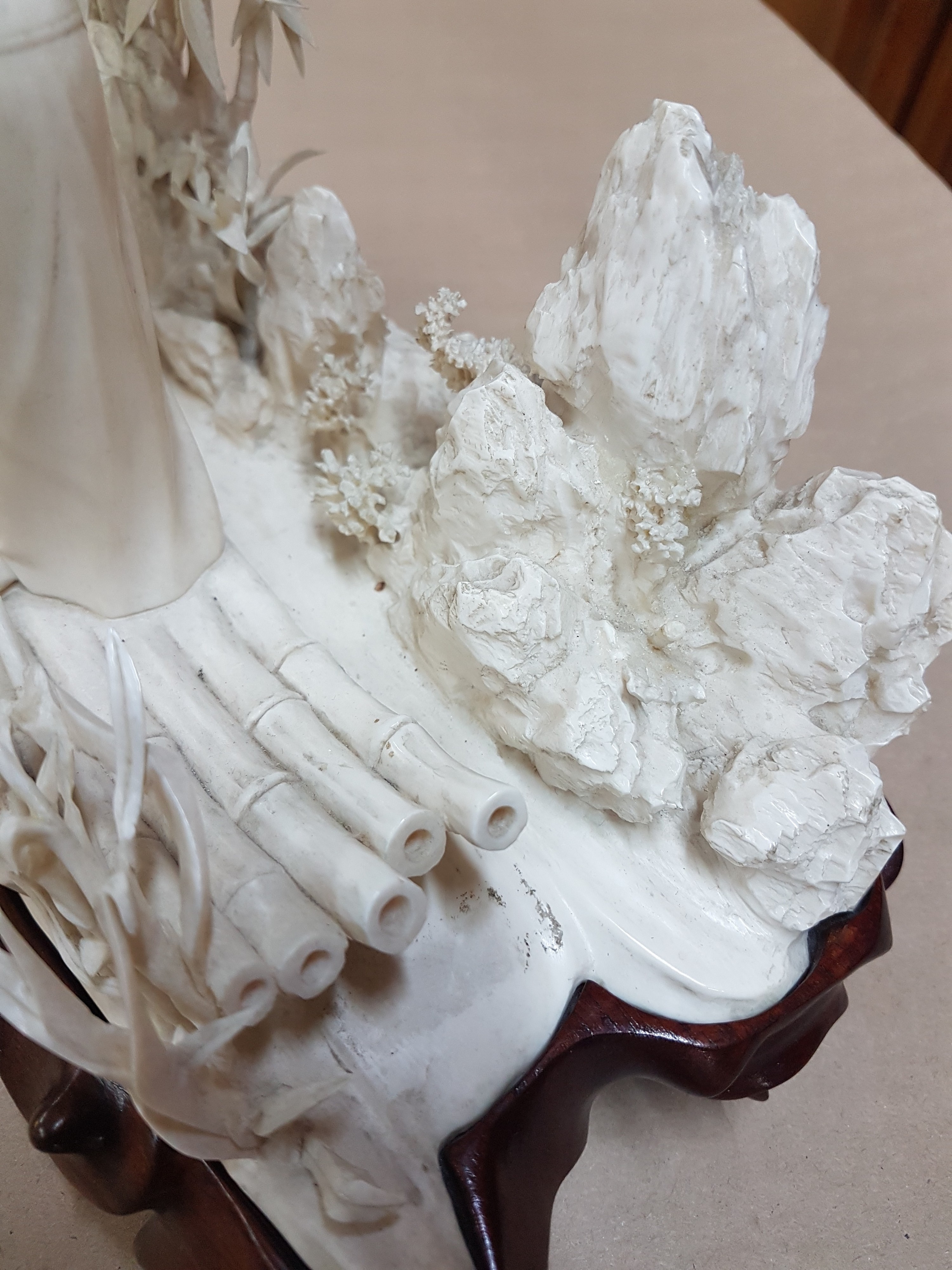 Detail s: Elfenbeinschnitzerei, China um 1900, Obstverkäuferin auf Floß, junge Frau mit erhobenem Arm und Stange, dahinter felsige Landschaft mit Bambus, ...