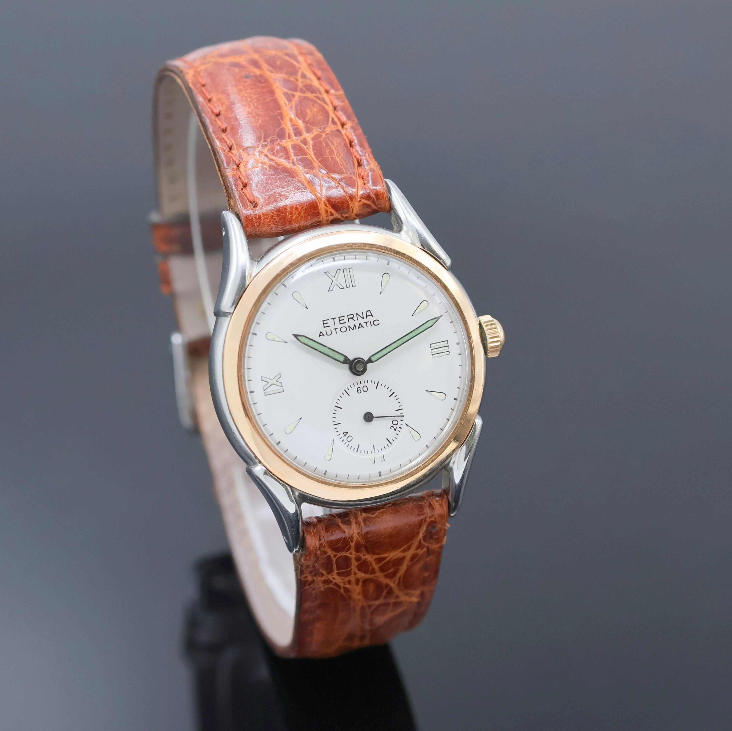 Detail b: ETERNA Armbanduhr mit Hammerautomatik in Stahl, Schweiz um 1945, Automatik, Boden verschr., verg. Lünette, silb. Zifferbl. rest., Leuchtind., ...