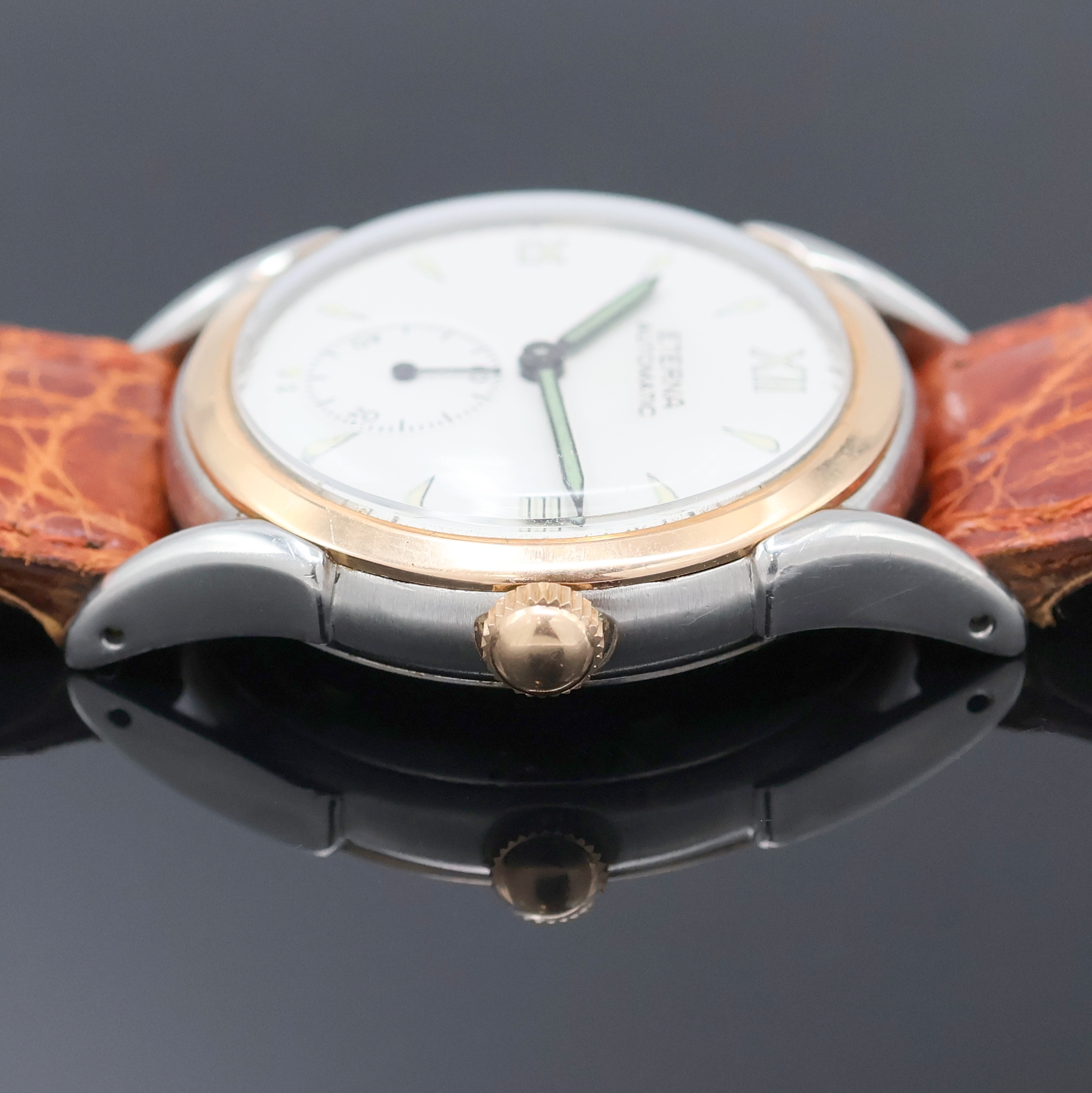 Detail c: ETERNA Armbanduhr mit Hammerautomatik in Stahl, Schweiz um 1945, Automatik, Boden verschr., verg. Lünette, silb. Zifferbl. rest., Leuchtind., ...