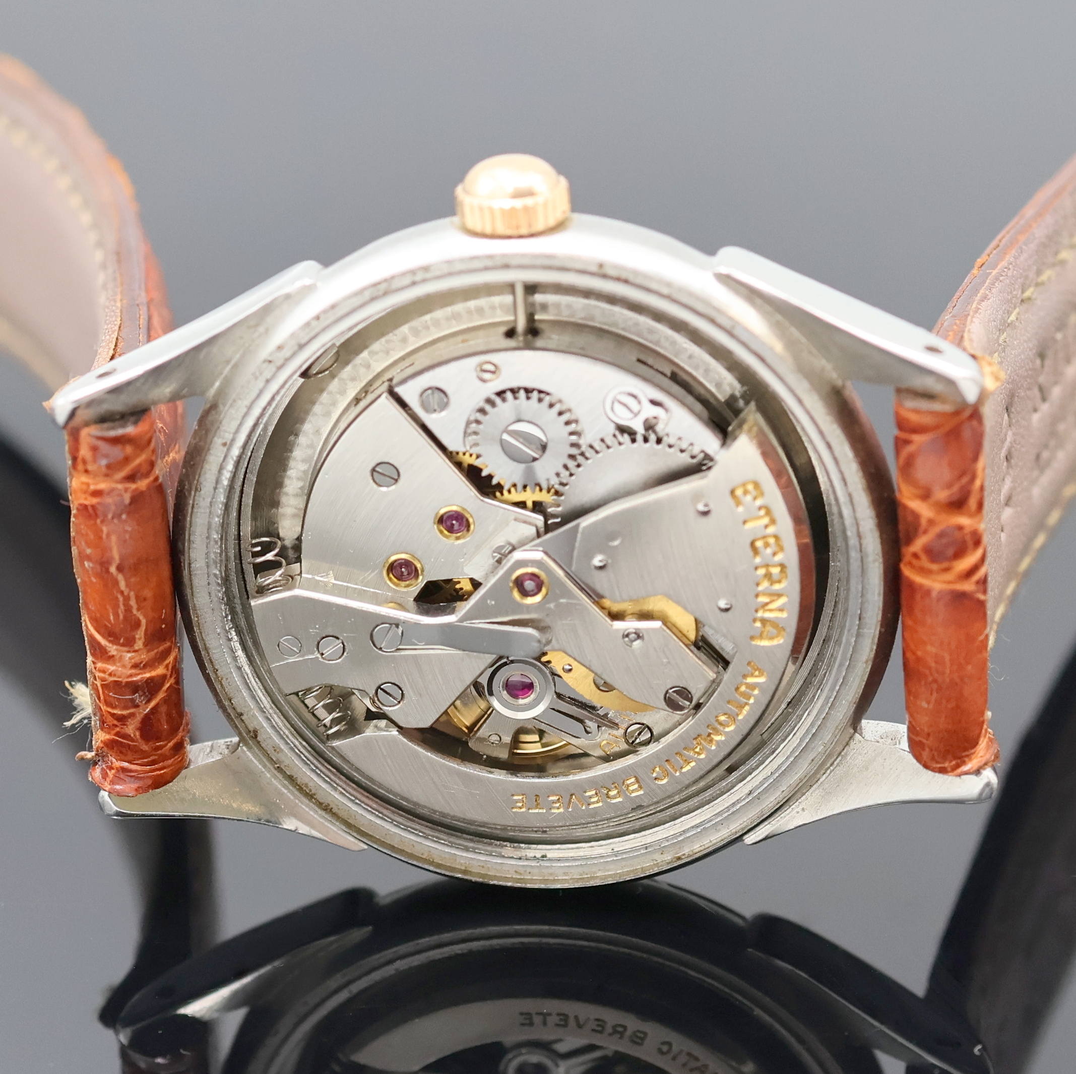 Detail e: ETERNA Armbanduhr mit Hammerautomatik in Stahl, Schweiz um 1945, Automatik, Boden verschr., verg. Lünette, silb. Zifferbl. rest., Leuchtind., ...