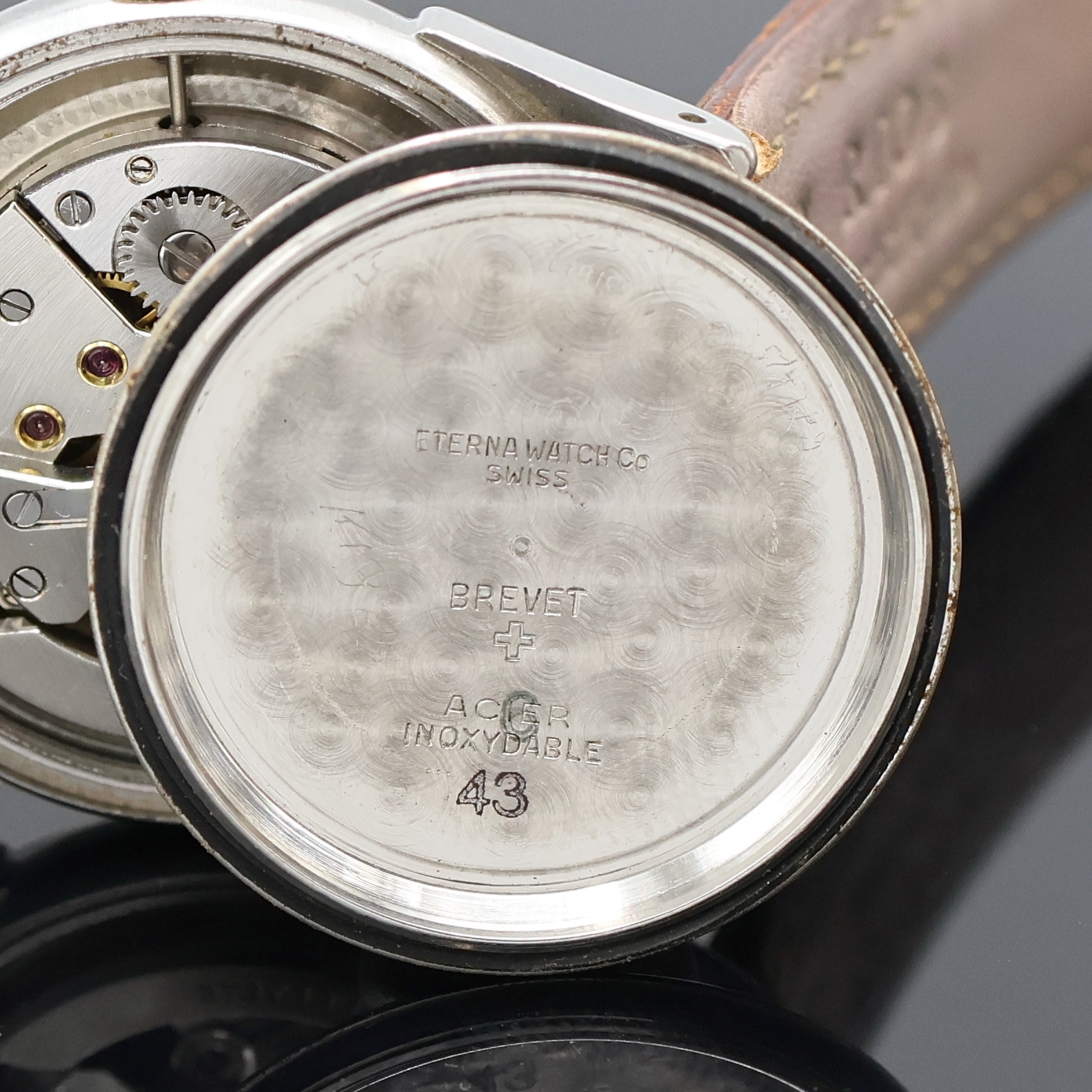 Detail g: ETERNA Armbanduhr mit Hammerautomatik in Stahl, Schweiz um 1945, Automatik, Boden verschr., verg. Lünette, silb. Zifferbl. rest., Leuchtind., ...