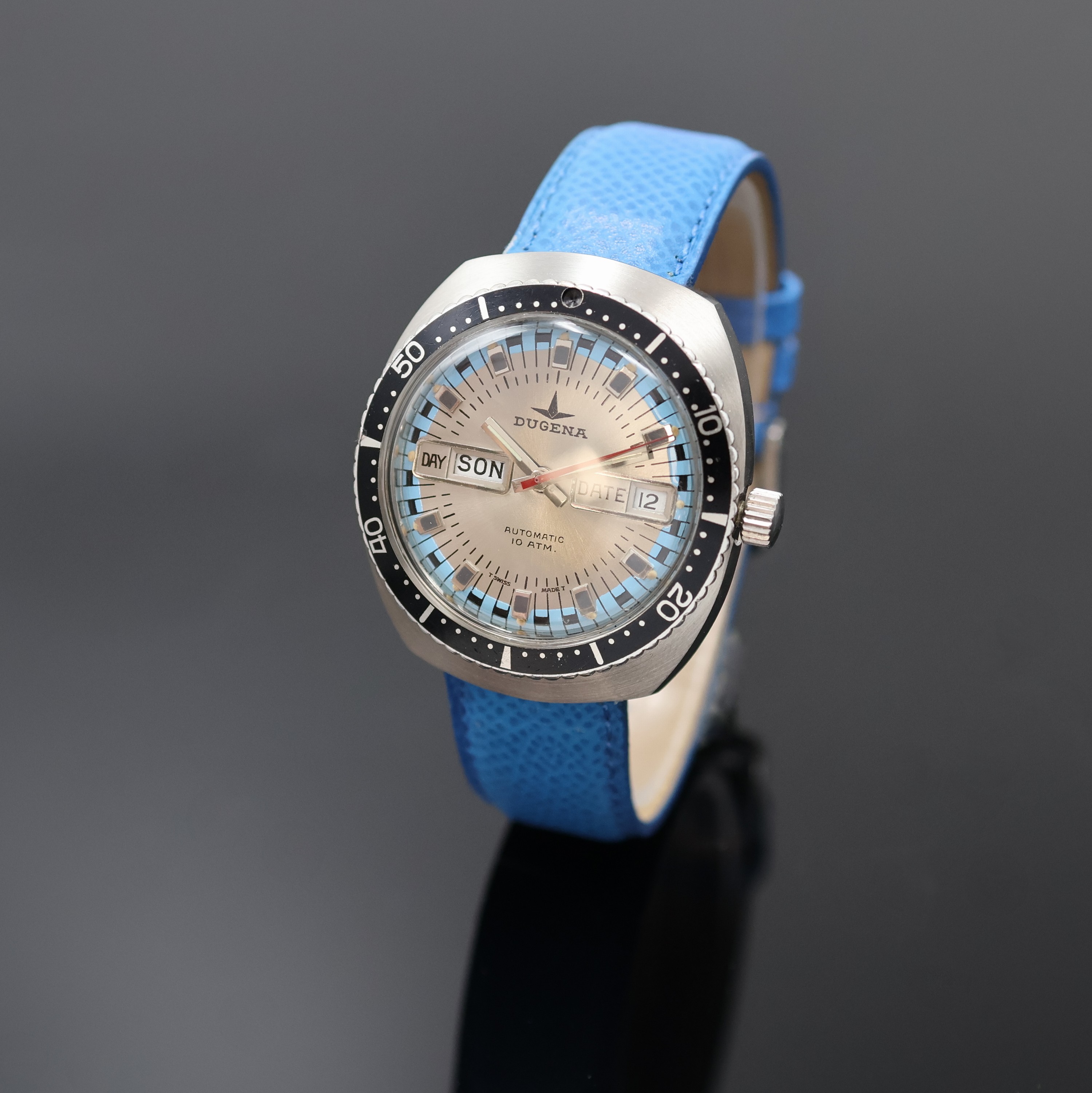 DUGENA Taucherarmbanduhr in Stahl, Schweiz um 1975, Automatik, Boden verschr., Lünette m. 60er Teilung beids. drehb., silb. Zifferbl. m. aufges. ...