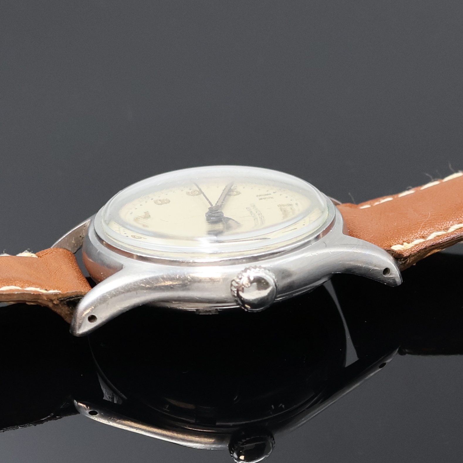 Detail b: UNIVERSAL GENEVE Armbanduhr in Stahl, Schweiz um 1940, Handaufzug, 2-teil. Geh., Boden verschr., silb. Zifferbl. m. arab. Leuchtzahlen pat., gebl. ...