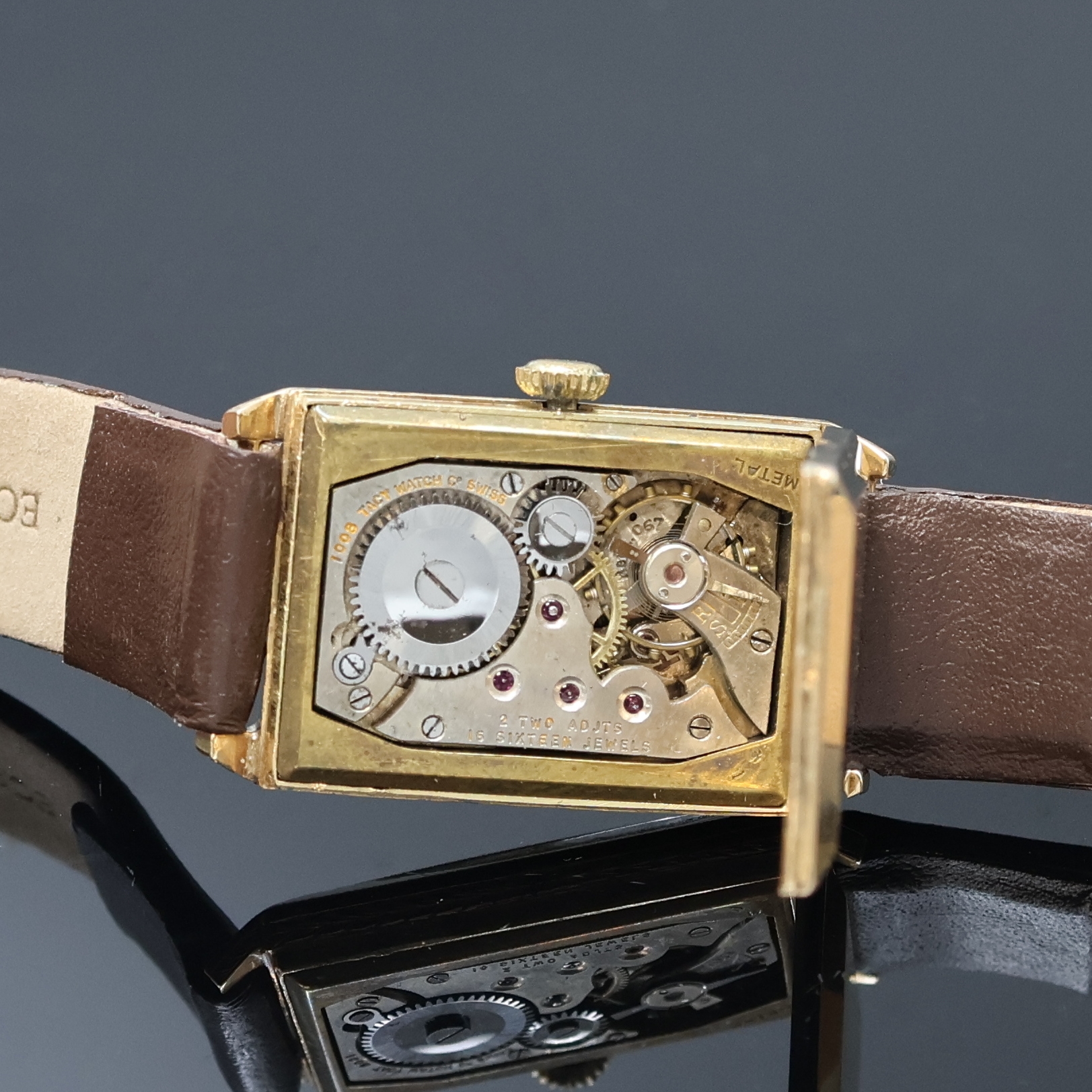 Detail e: TAVANNES rechteckige Armbanduhr in GG 585/000, Schweiz um 1930, Handaufzug, 2- teil. Scharniergeh., floral grav. Rand, gold. Zifferbl. m. arab. ...