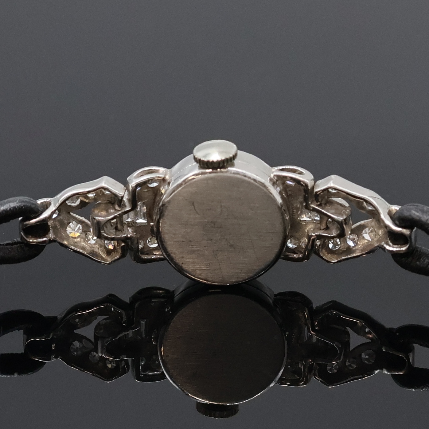 Detail d: Diamantbesetzte Damenarmbanduhr in Platin/ Iridium mit Schließe in WG 585/000, Schweiz um 1950, Handaufzug, 2-tlg. Geh. m. bewegl. Anstößen, Boden ...