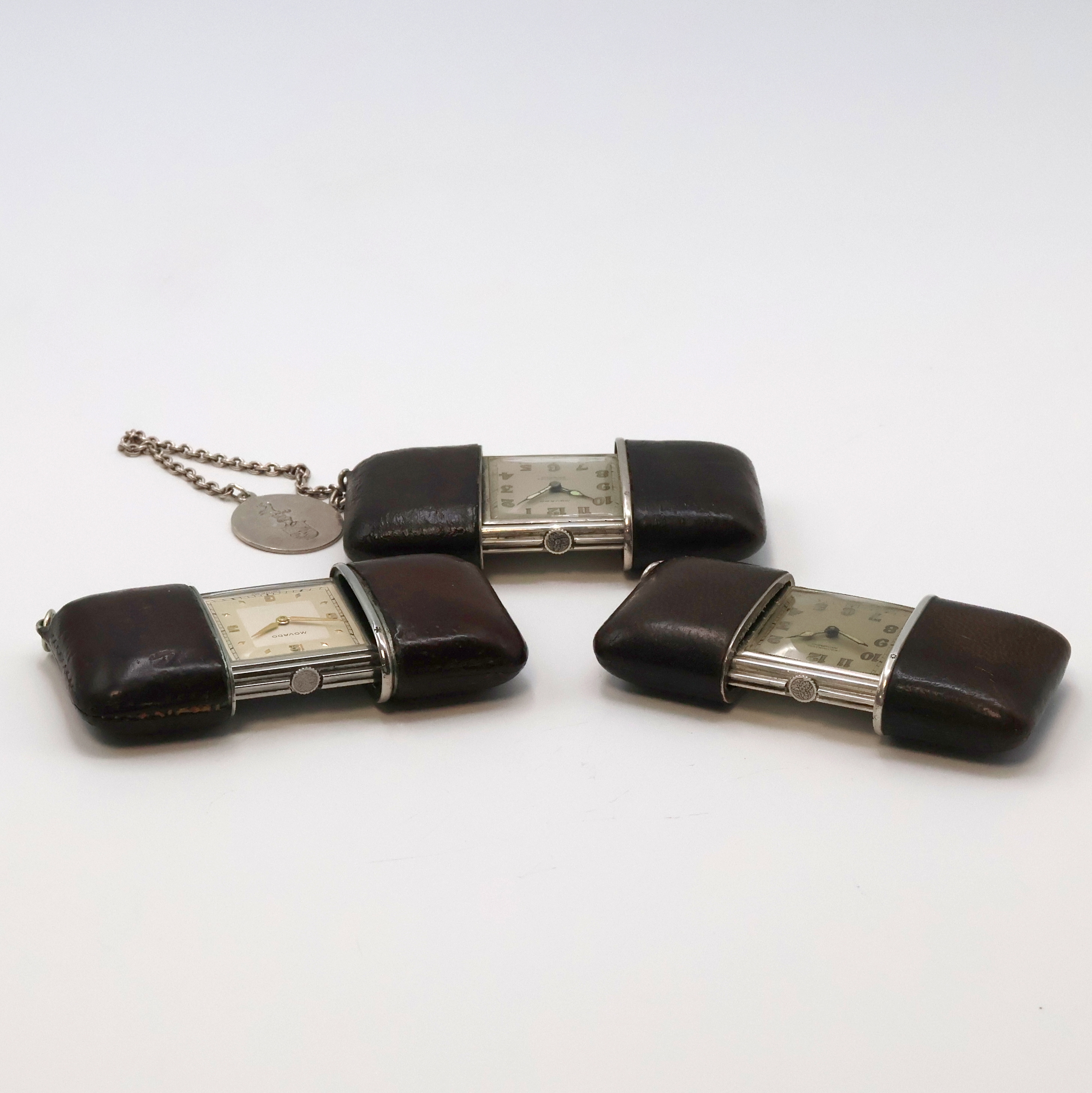 Detail d: 3 MOVADO Ermeto Schiebeührchen in Silber und Nickel, Schweiz um 1930 bis 1950, alle mit Schiebeaufzug, Leder-bezogene Geh., davon 2 in Silber, silb. ...