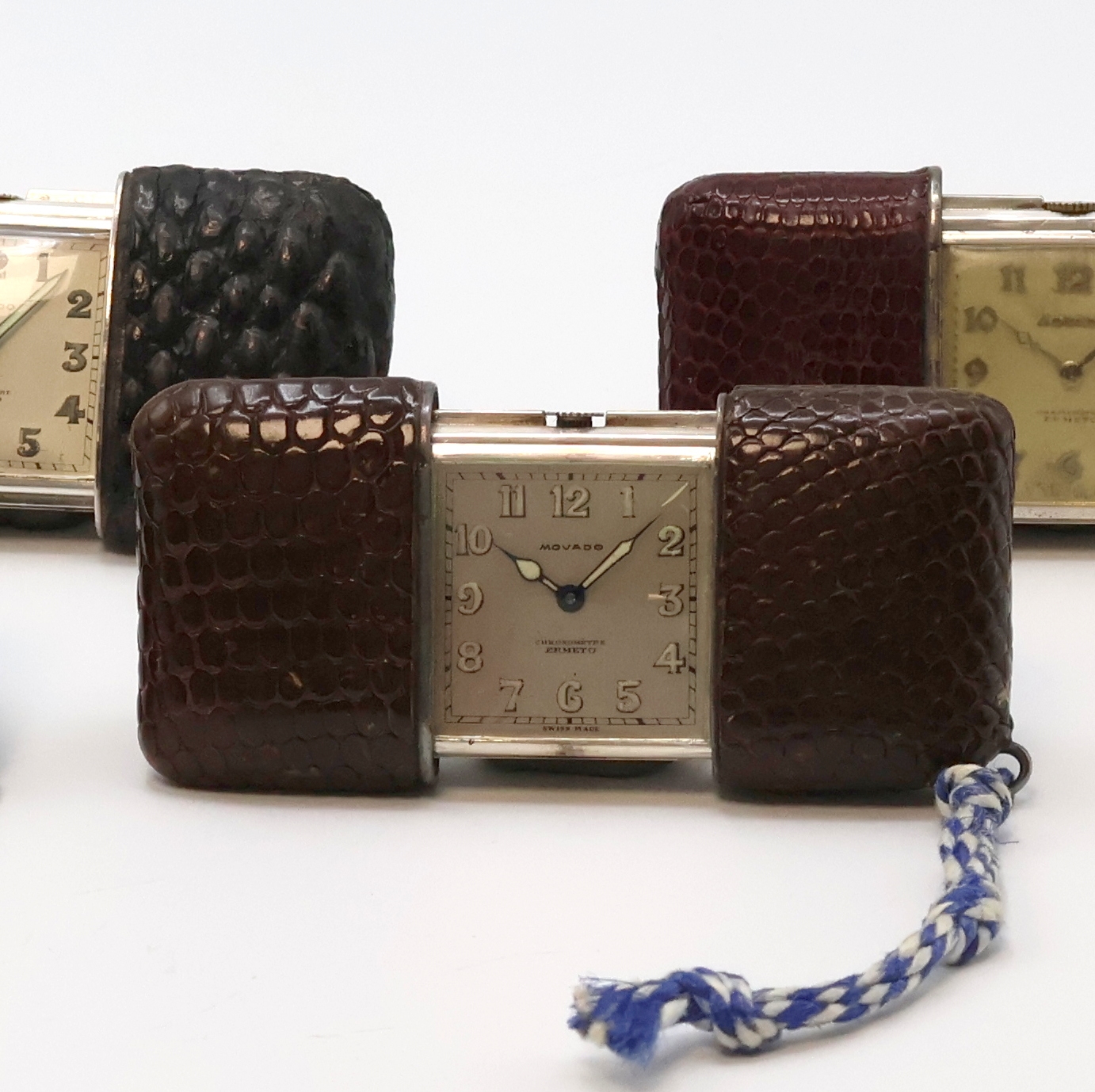 Detail b: 4 MOVADO Ermeto Schiebeührchen in Silber und Nickel, Schweiz um 1930 bis 1950, Schiebeaufzug, Leder-bezogene Geh., davon 3 in Silber, silb. ...