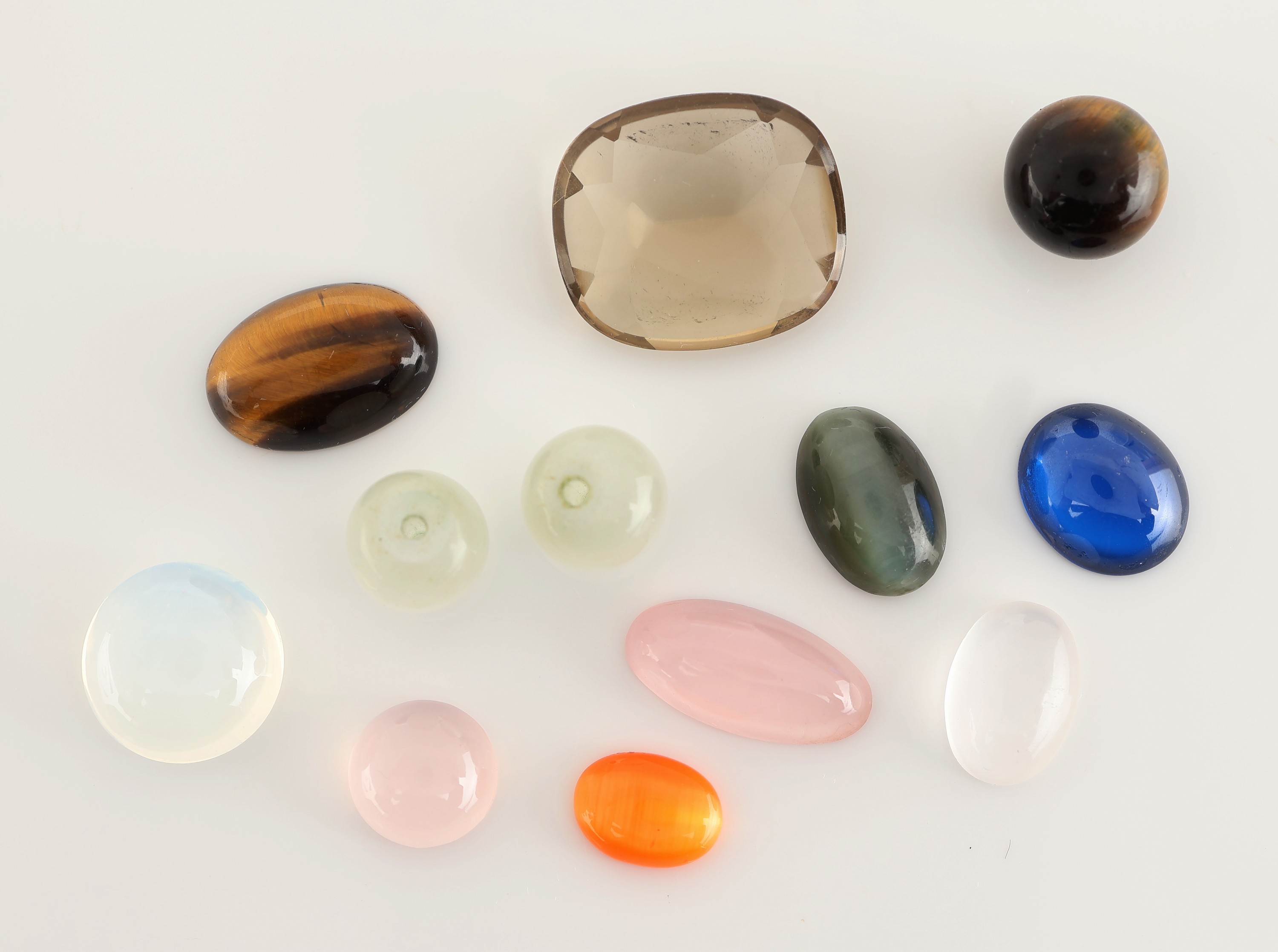 Image 27059205 - Lot 12 lose Farbsteine, zus. ca. 40.70 ct, u.a. Rosenquarz, Tigerauge, Mondstein, ...