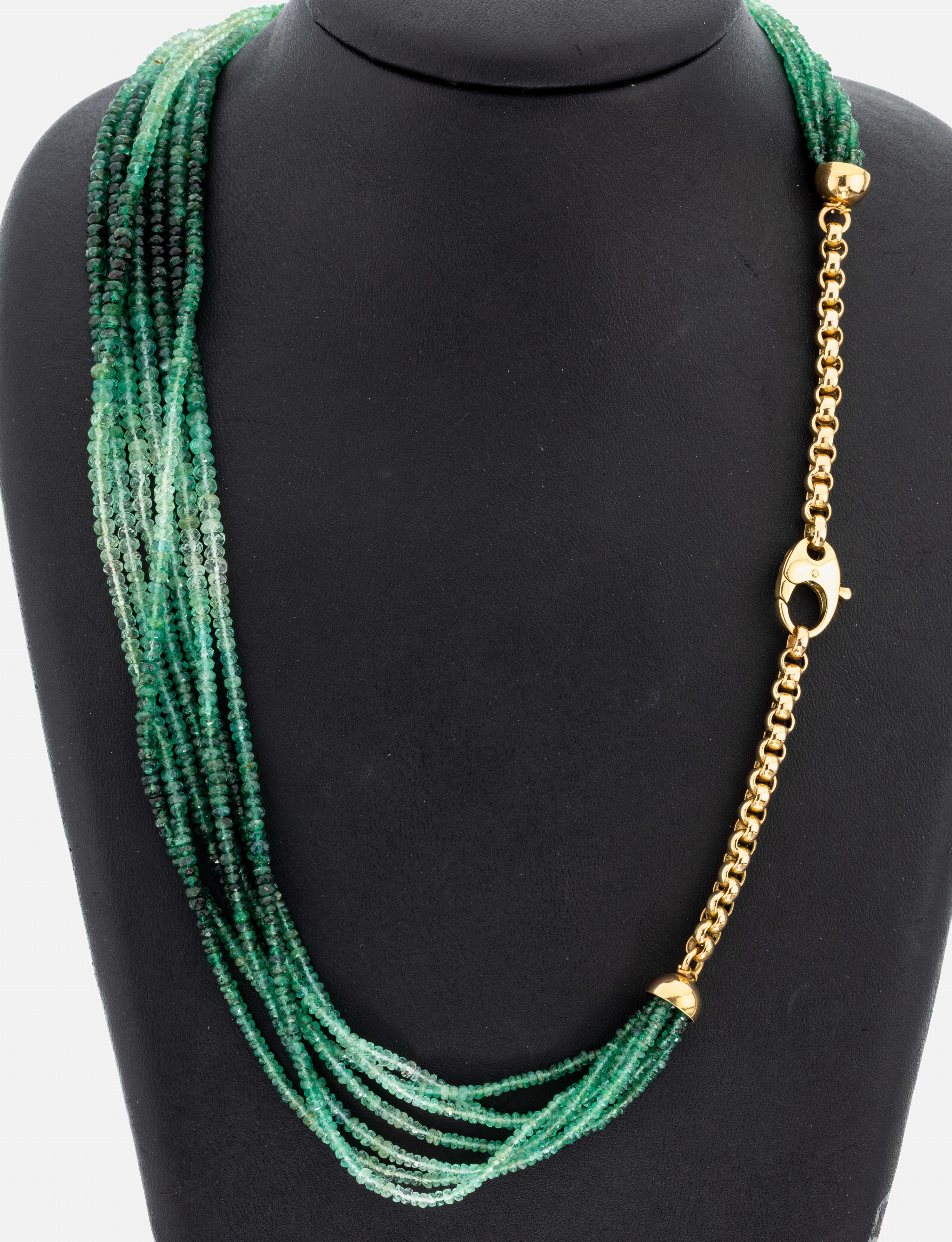 Detail a: Farbstein-Collier mit 18 kt Gold Schließe, GG 750/000 gepr., 7 rhg. facett. Smaragde in versch. Farbnuancen, L. ca. 56 cm, ca. 51.7 g