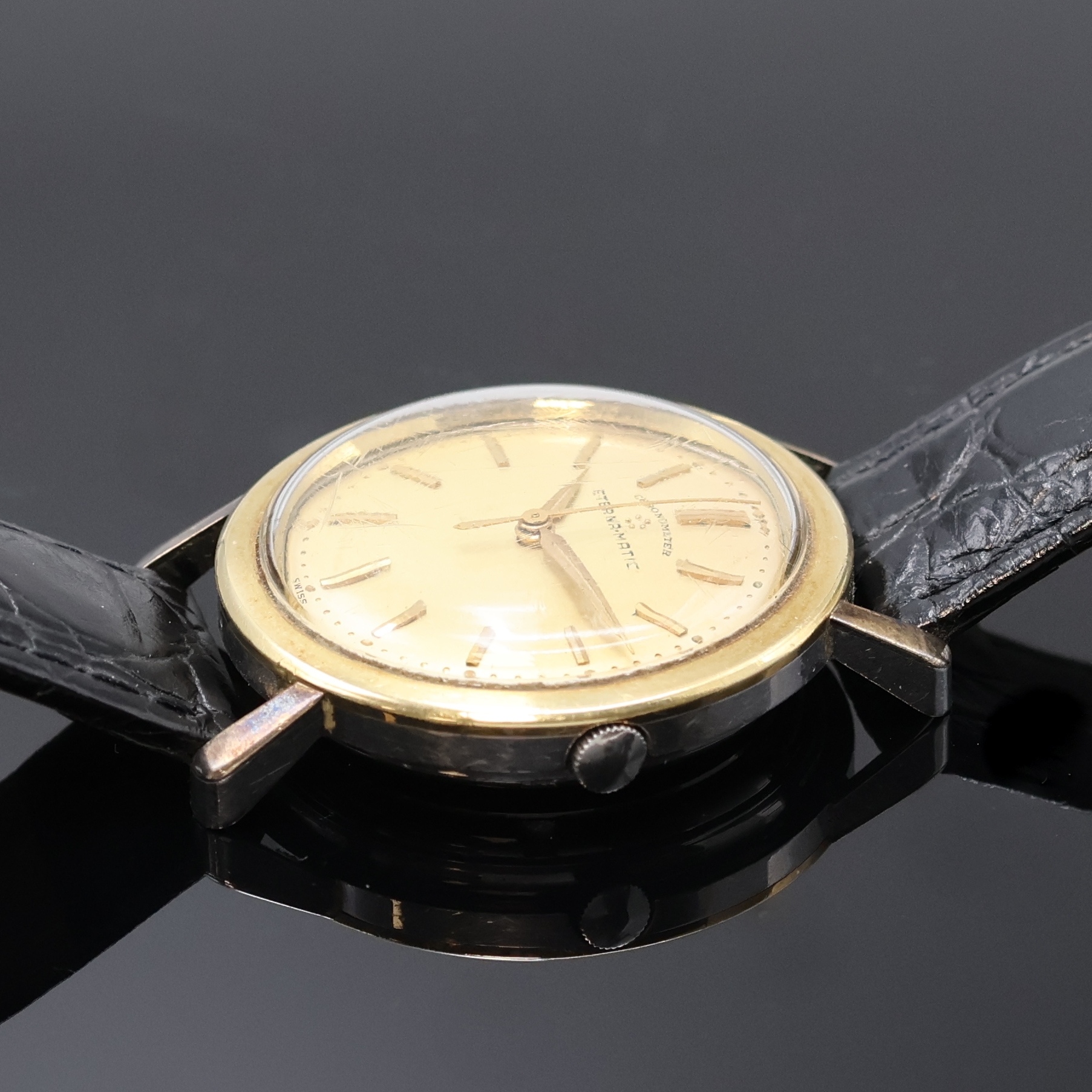 Detail b: ETERNA-MATIC Chronometer Armbanduhr, Schweiz um 1958, Automatik, Edelstahlgeh., Lünette wie Bandanst. mit Goldhaube, vers. Zifferblatt m. aufges. ...